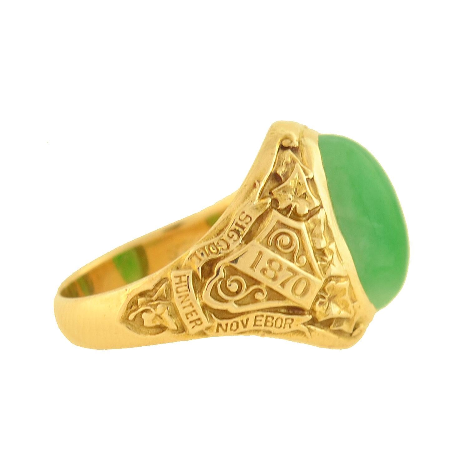 A wonderful commemorative class ring from the late Art Deco (ca1928) era, manufactured by legendary maker Tiffany & Company! Crafted in 14kt yellow gold, this striking piece from Hunter College features a gorgeous jade stone. Resting in the center