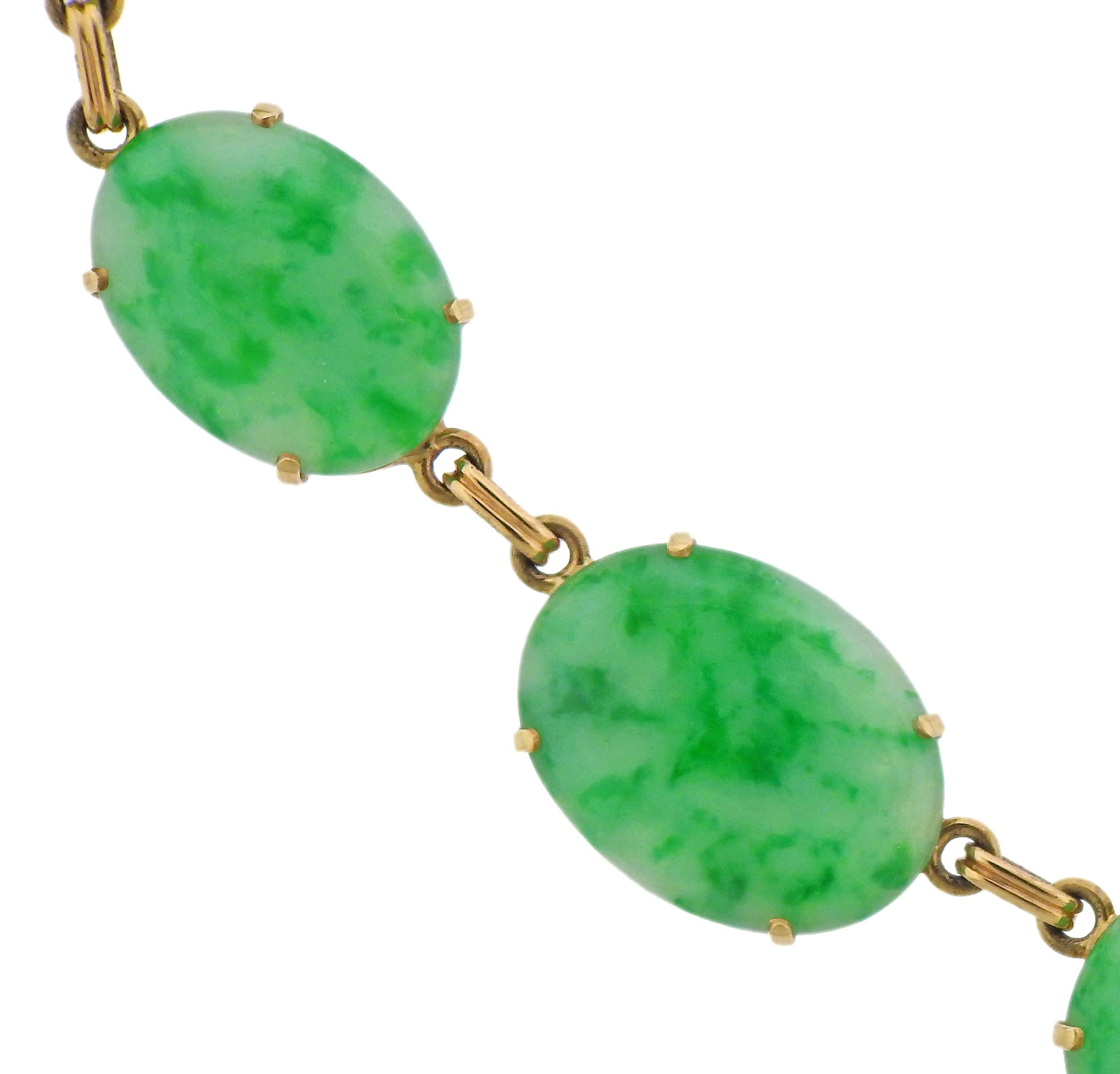 Art Deco 14k gold necklace by Tiffany & Co, with oval jade stones, measuring from 16mm x 12mm to 30mm x 22mm. Necklace is 16.25