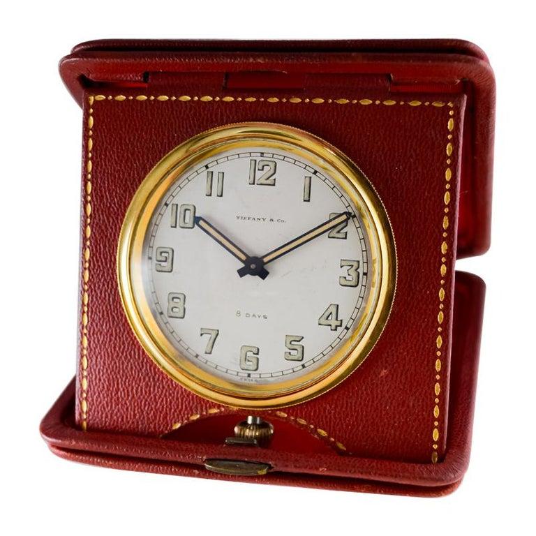 FACTORY / HOUSE: Concord for Tiffany & Co. 
STYLE / REFERENCE: 8 Day Leather Travel Clock
METAL / MATERIAL: Red Leather
CIRCA / YEAR: 1940's
DIMENSIONS / SIZE: 4 Inches Square
MOVEMENT / CALIBER: Manual Winding / 15 Jewels / Concord 8 Days
DIAL /
