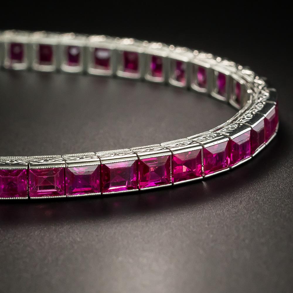 The finest of the finest by America's premier jeweler of the Art Deco era (circa 1920s-30s) - Tiffany & Company. Forty-five square-cut rubies, together weighing 22 carats, create a seamless flash of electric, crystalline red across your wrist in