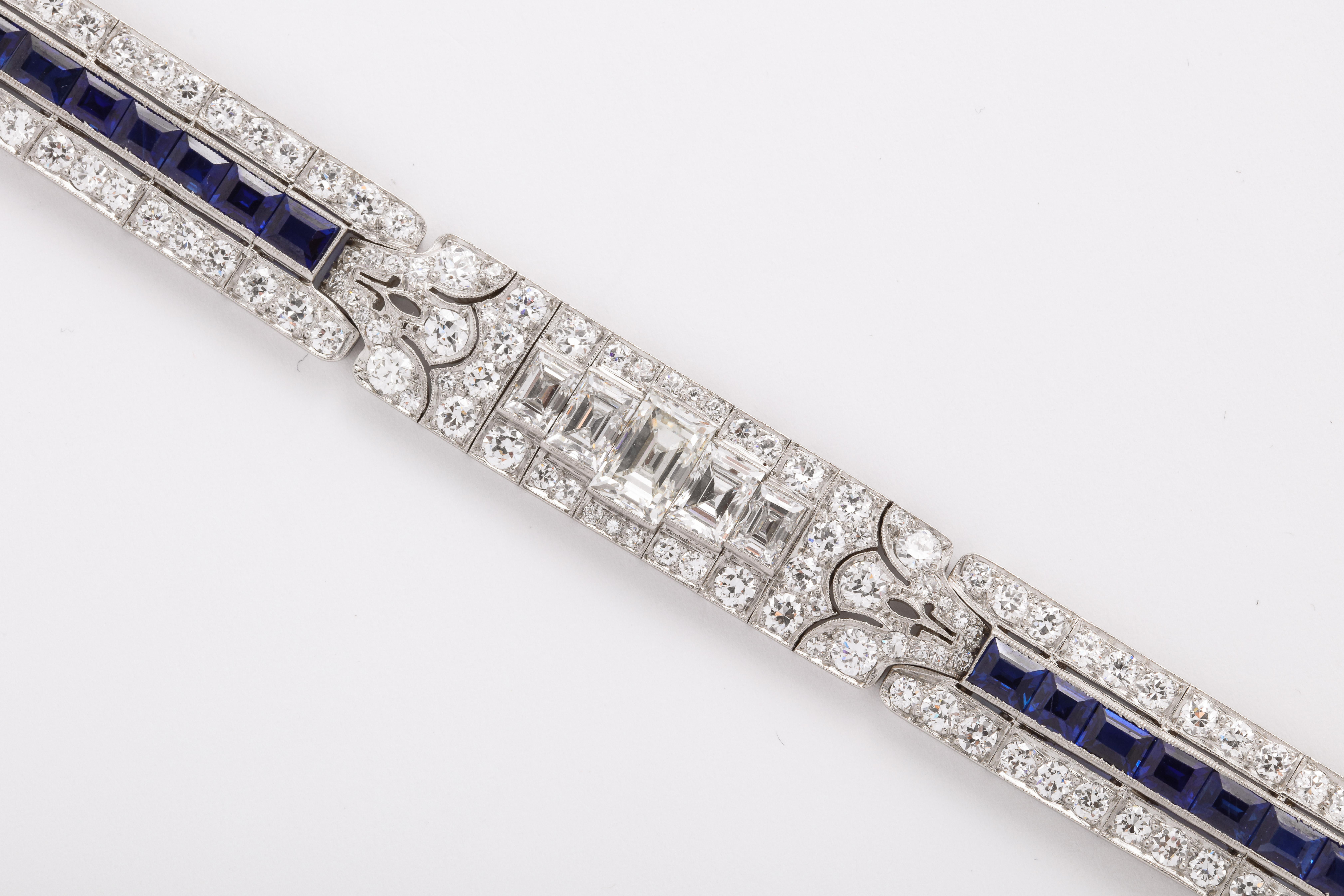 Platinum, Diamond & Sapphire Line Bracelet
by Tiffany & Co. 
A rich line of step-cut square shaped sapphires weighing an estimated 14.50 carats bring your eye to a beautifully designed all diamond centerpiece, featuring 5 emerald cut diamonds that