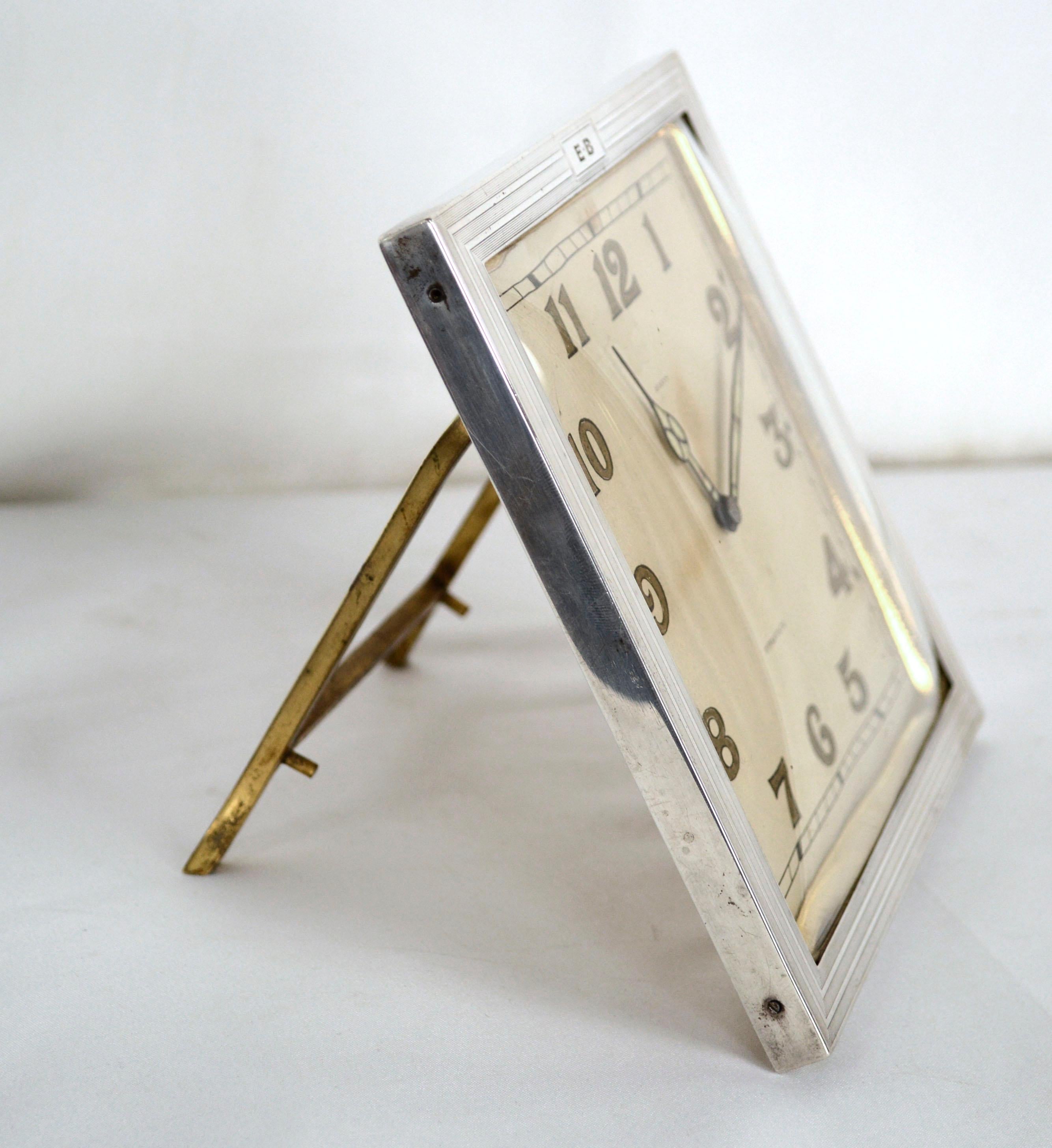 Elegant c.1920's art deco square desk clock by Tiffany & Co, in excellent working condition. Heavy cast bronze base with sterling silver frame and Lexan/plexiglass face, sterling silver, .925, frame is inscribed with initials 