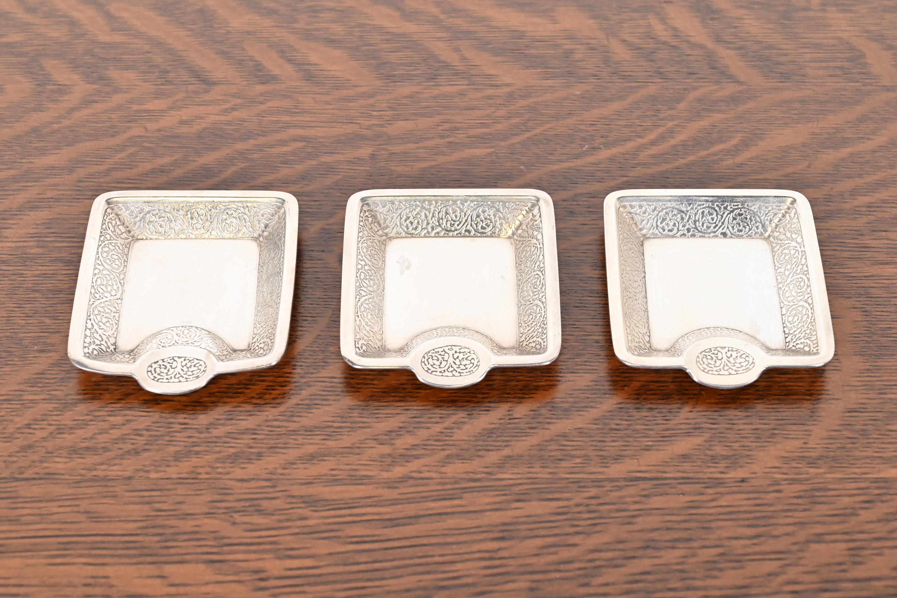 A gorgeous set of three antique sterling silver ashtrays or catchall trays

By Tiffany & Co. (signed to the underside)

USA, Circa Early 20th Century

Each measures: 3.25