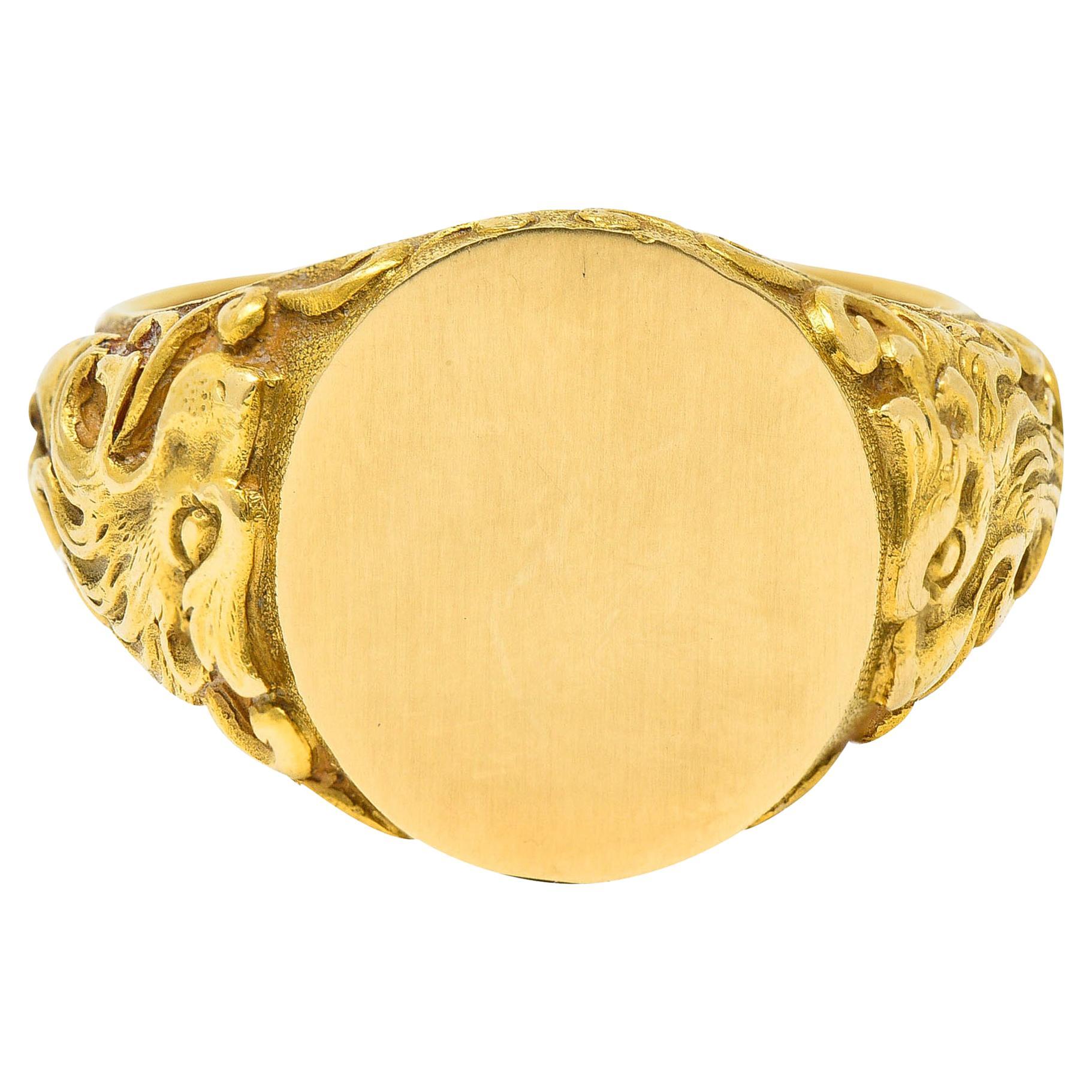 Signet ring has an oval signet face measuring approximately 14.0 x 13.0 mm

With a finely brushed finish and highly rendered whiplash shoulders

Completed by a roaring lion motif

Tested as 18 karat gold

Fully signed Tiffany & Co. with an