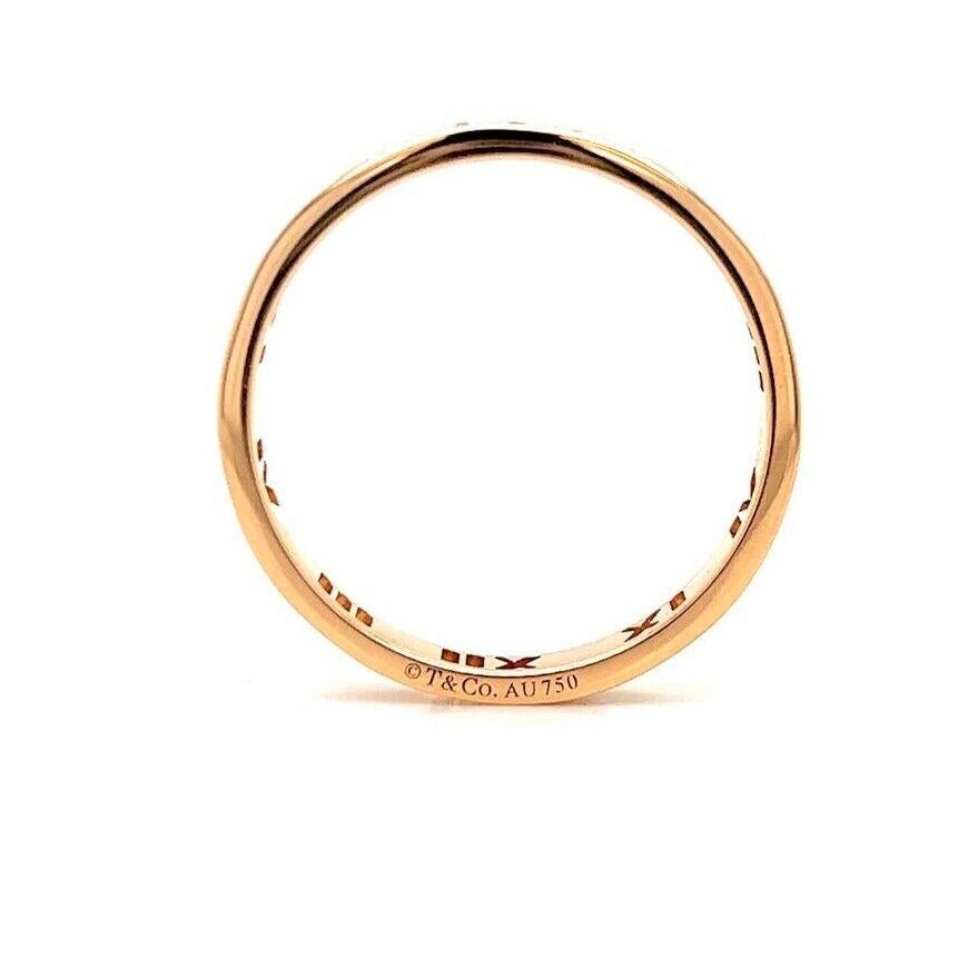 Tiffany & Co. Atlas 18k Rose Gold and Diamonds Roman Numeral Band Ring Size 9

Condition:  Excellent Condition, Professionally Cleaned and Polished
Metal:  18k Gold (Marked, and Professionally Tested)
Weight:  3.2g
Diamonds:  Four Brilliant Round