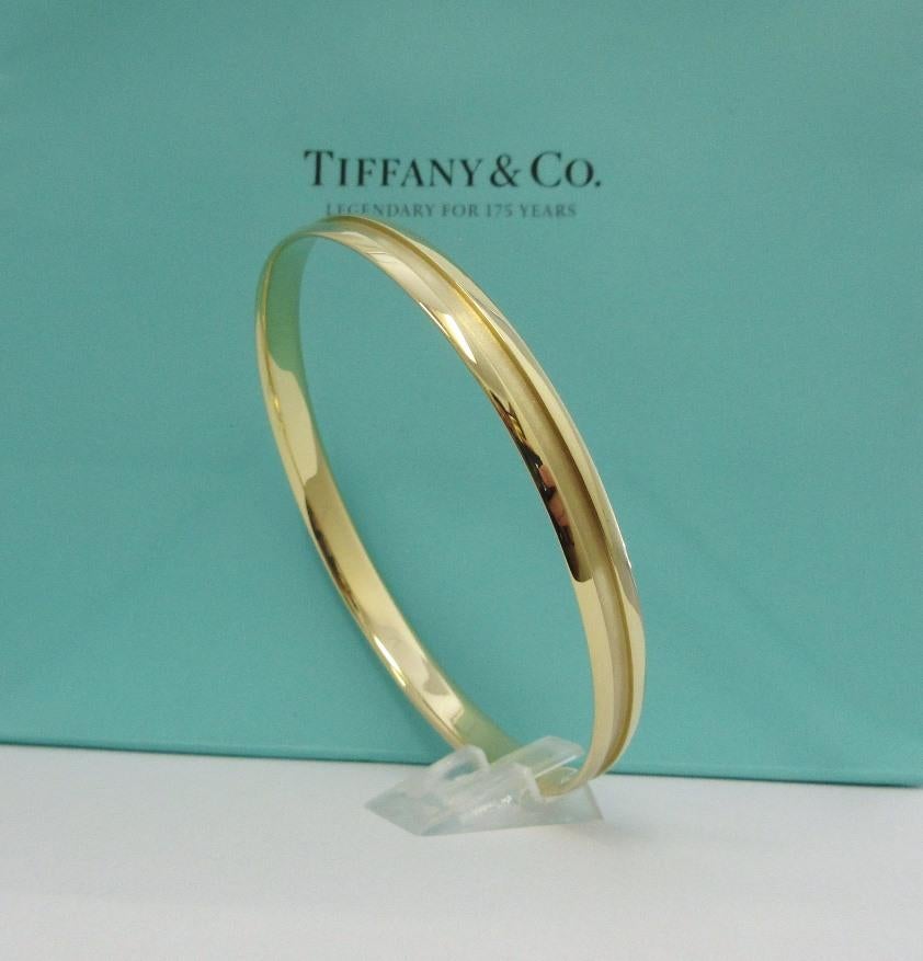 TIFFANY & Co. Atlas 18K Gold Groove Bangle Bracelet 

Metal: 18K Yellow Gold
Weight: 17.20 grams
Measurement: 63mm(2.48