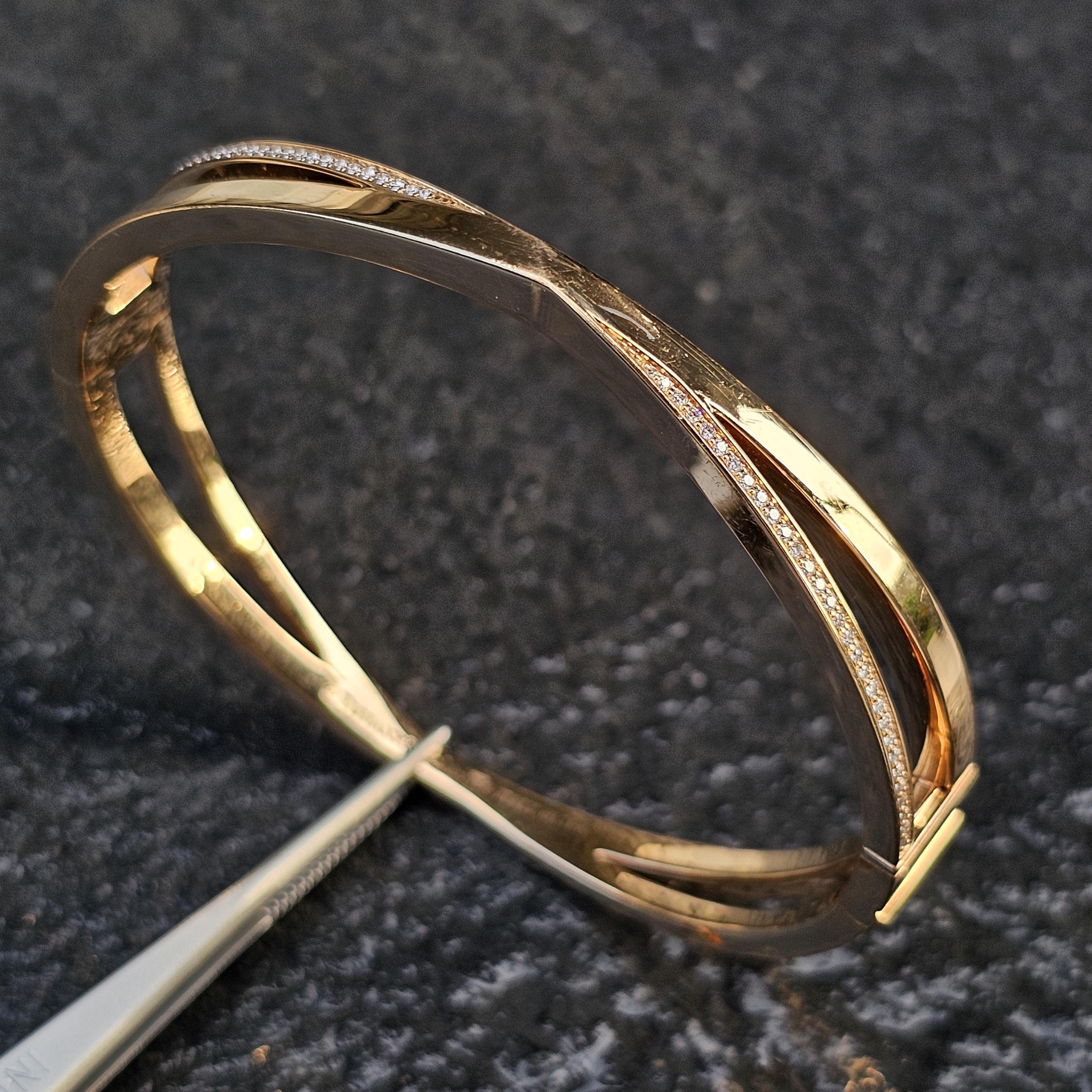 Enhance your collection with this stunning Tiffany & Co. bangle bracelet. Crafted from 18k rose gold, its elegant design features a graceful twist adorned with white diamonds, adding a touch of brilliance. This piece is perfect for those who