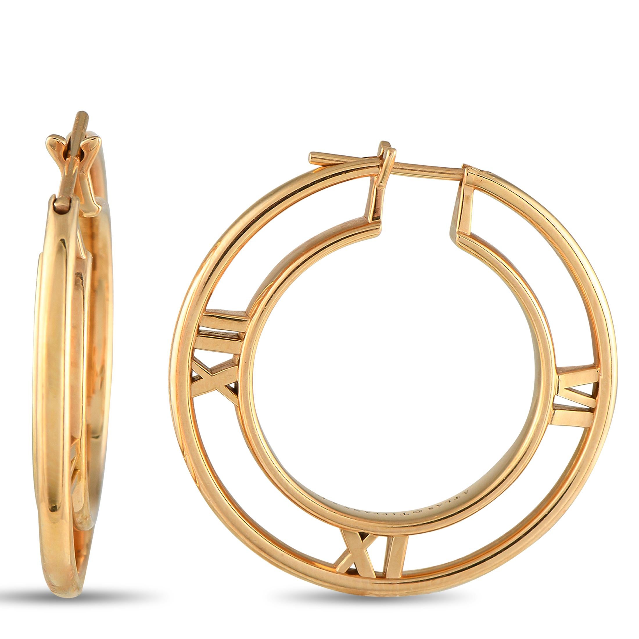 These Tiffany & Co. Atlas hoop earrings poised to make a statement. Crafted from lustrous 18K Rose Gold, the understated design comes to life thanks to Roman numeral motifs  a signature from the luxury brands iconic collection. Each one measures