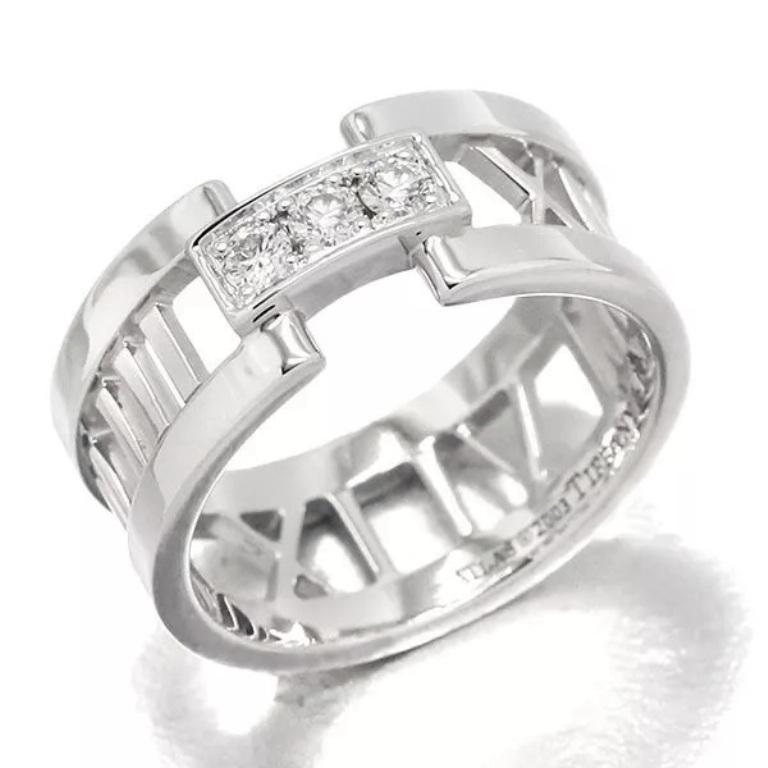 TIFFANY & Co. Atlas 18K White Gold 3 Diamonds Open Ring 7

Metal: 18K White Gold
Size: 7
Band Width: 8.5mm
Weight: 7.20 grams
Diamond: 3 round brilliant diamonds, carat total weight .10 approx.
Hallmark: ATLAS ©2003 TIFFANY&Co. 750 ITALY
Condition: