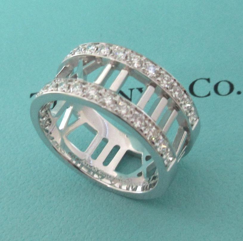 TIFFANY & Co. Atlas 18K White Gold Half Circle Diamond Open Ring 6.5

Streamlined and modern, the Atlas collection shines with graphic sophistication and bold simplicity. A Roman numeral motif with diamonds adds a modern touch to this classic