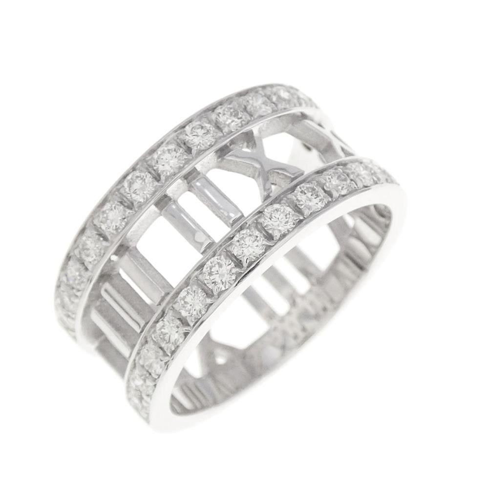 TIFFANY & Co. Atlas 18K White Gold Half Circle Diamond Open Ring 7

Streamlined and modern, the Atlas collection shines with graphic sophistication and bold simplicity. A Roman numeral motif with diamonds adds a modern touch to this classic