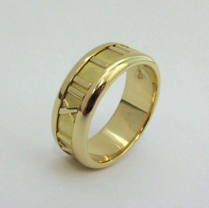 TIFFANY & CO. Atlas 18K Yellow Gold Numeric Ring 6.5

Metal: 18K Yellow Gold
Size: 6.5 
Band Width: 7mm
Weight: 7.90 grams
Hallmark: TIFFANY&CO.©1995 750 ITALY
Condition: Excellent condition, like new

Limited edition, no longer available for sale