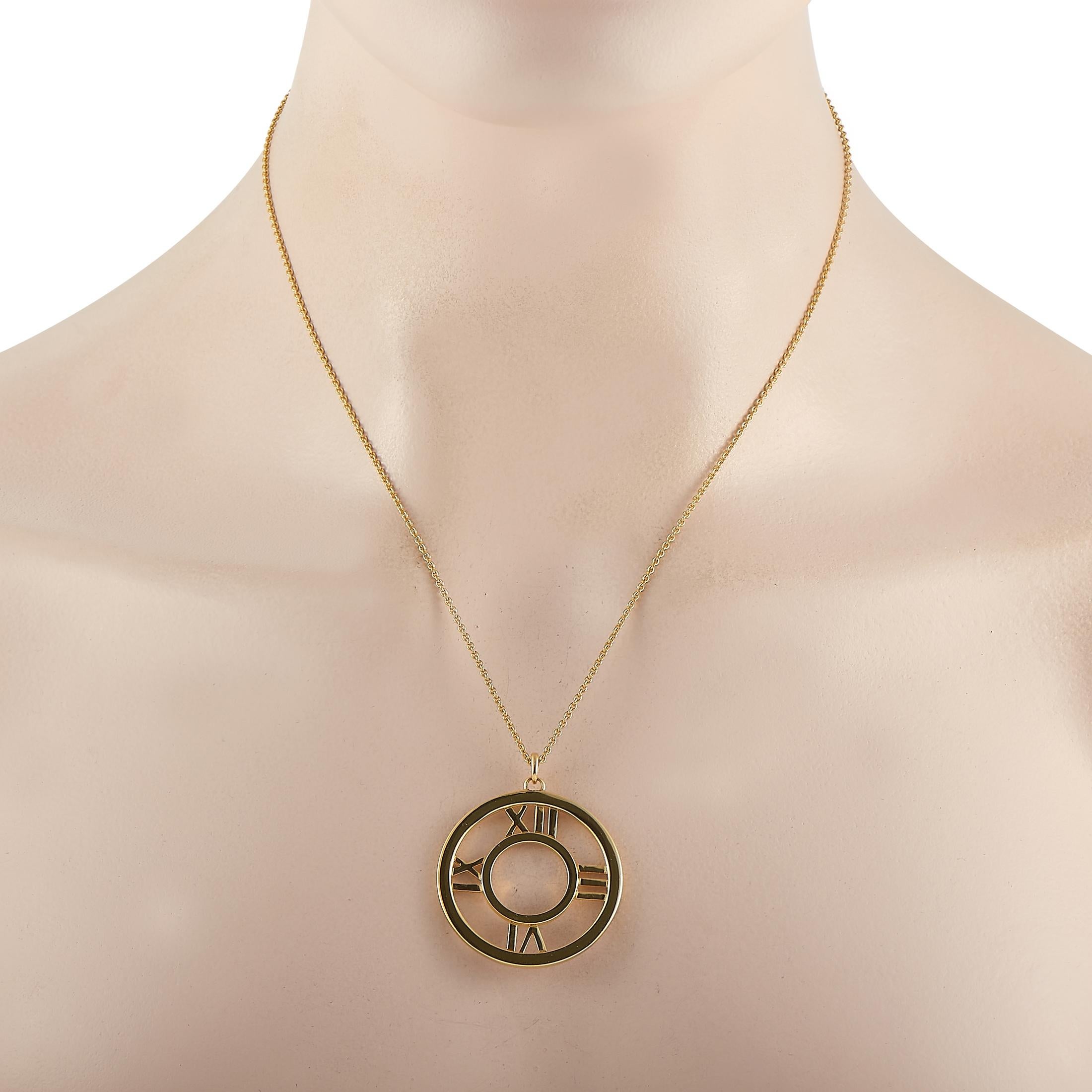 From Tiffany & Co. Atlas Collection, this circular pendant is fashioned in 18K yellow gold and is designed with a round open frame with sculpted Roman numerals. You won't go wrong with the neat silhouette, classy design, and timeless elegance of