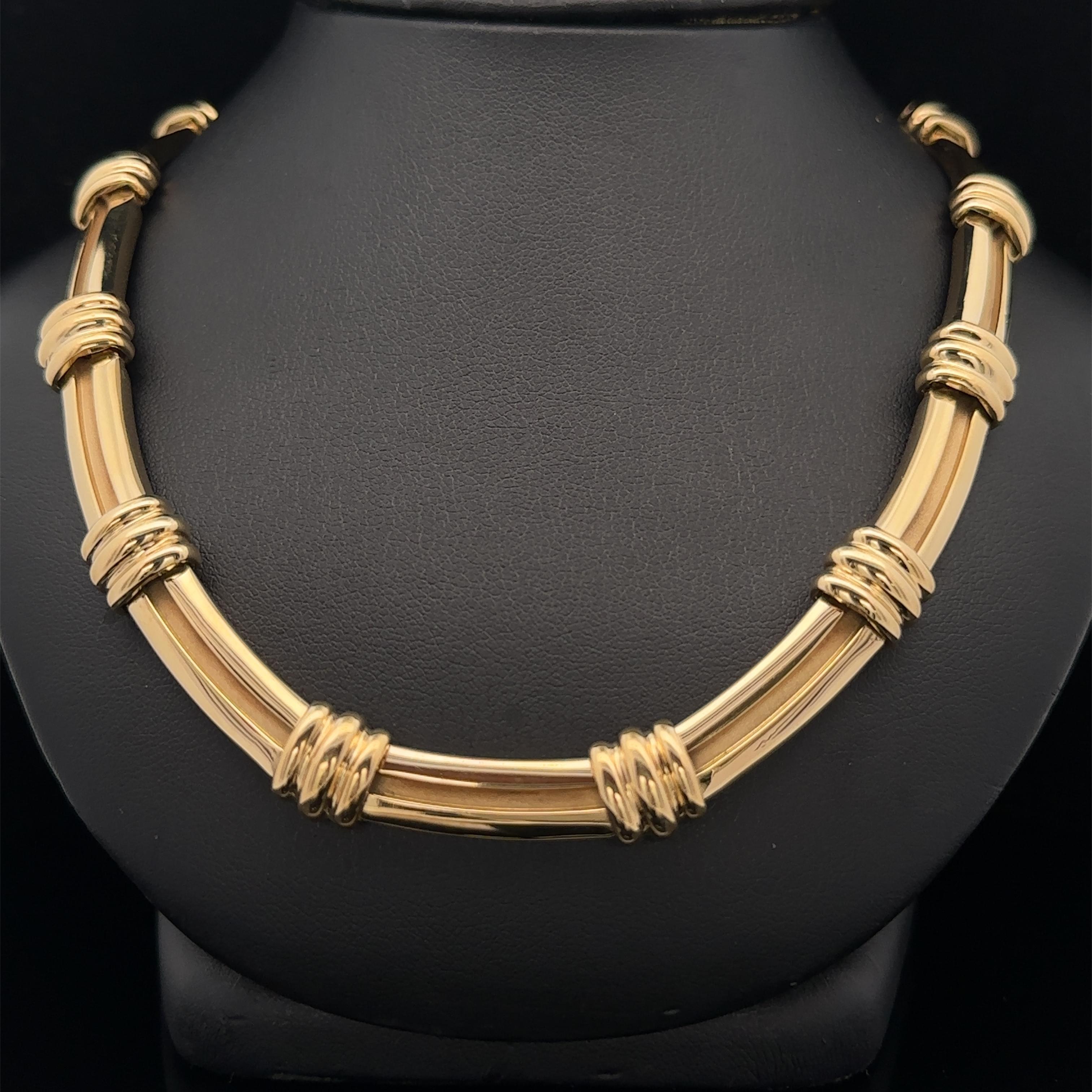 Material: Solid 18k Yellow Gold
Weight: 83.46 Grams
Chain Type: Grooved Geometric Link
Chain Length: Measures 15.5 Inches Next to a Ruler. Will Comfortably Fit a 15 Inches Neck (fitted on a neck)
Chain Width: 10.3mm (at the connecting links)
Chain