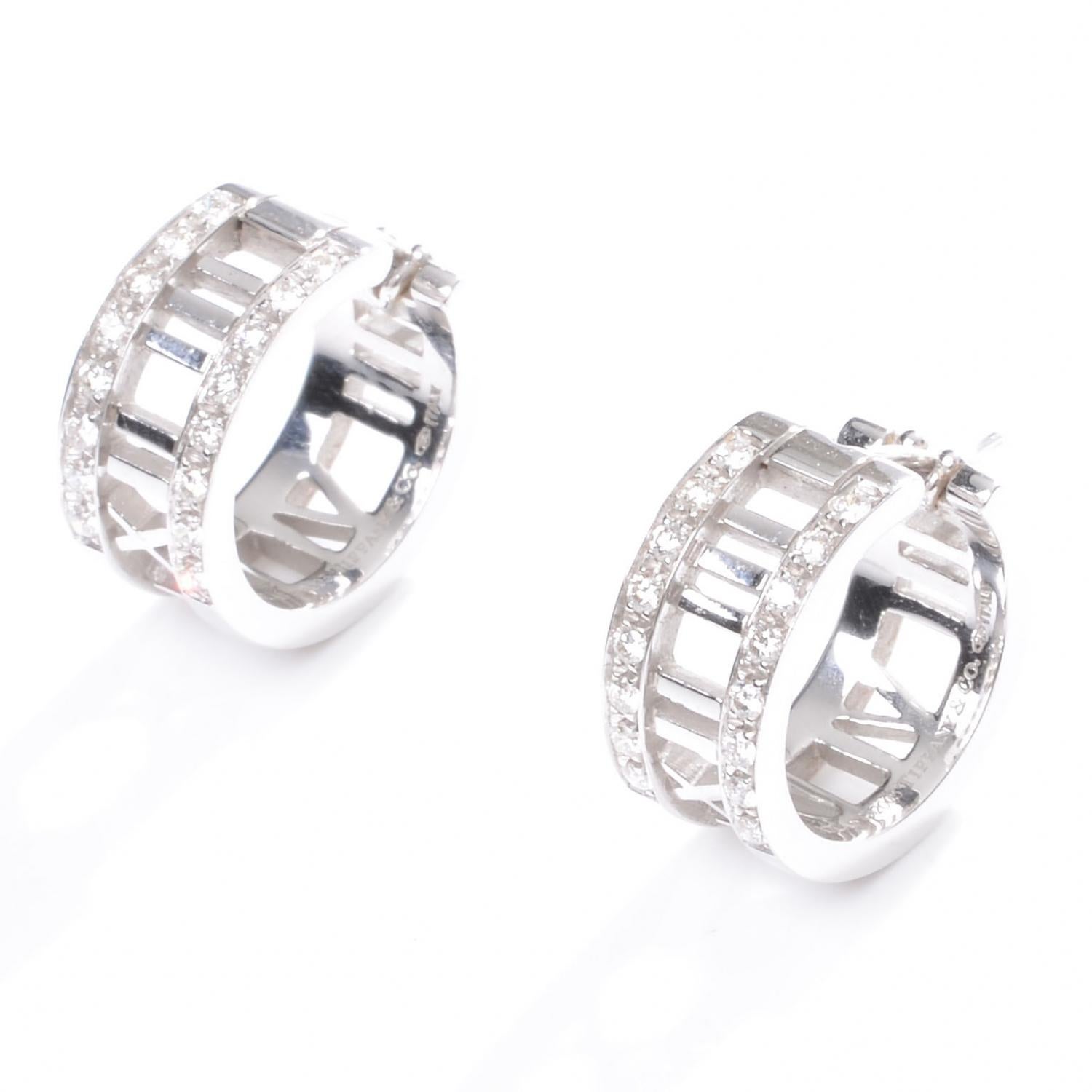 Tiffany & Co. Atlas earrings with diamonds finely crafted in 18k white gold.
A true classic authentic pair of earrings by Tiffany & Co., from the ATLAS collection. These beauties are crafted in 18kt white gold with polished and textured finish. They