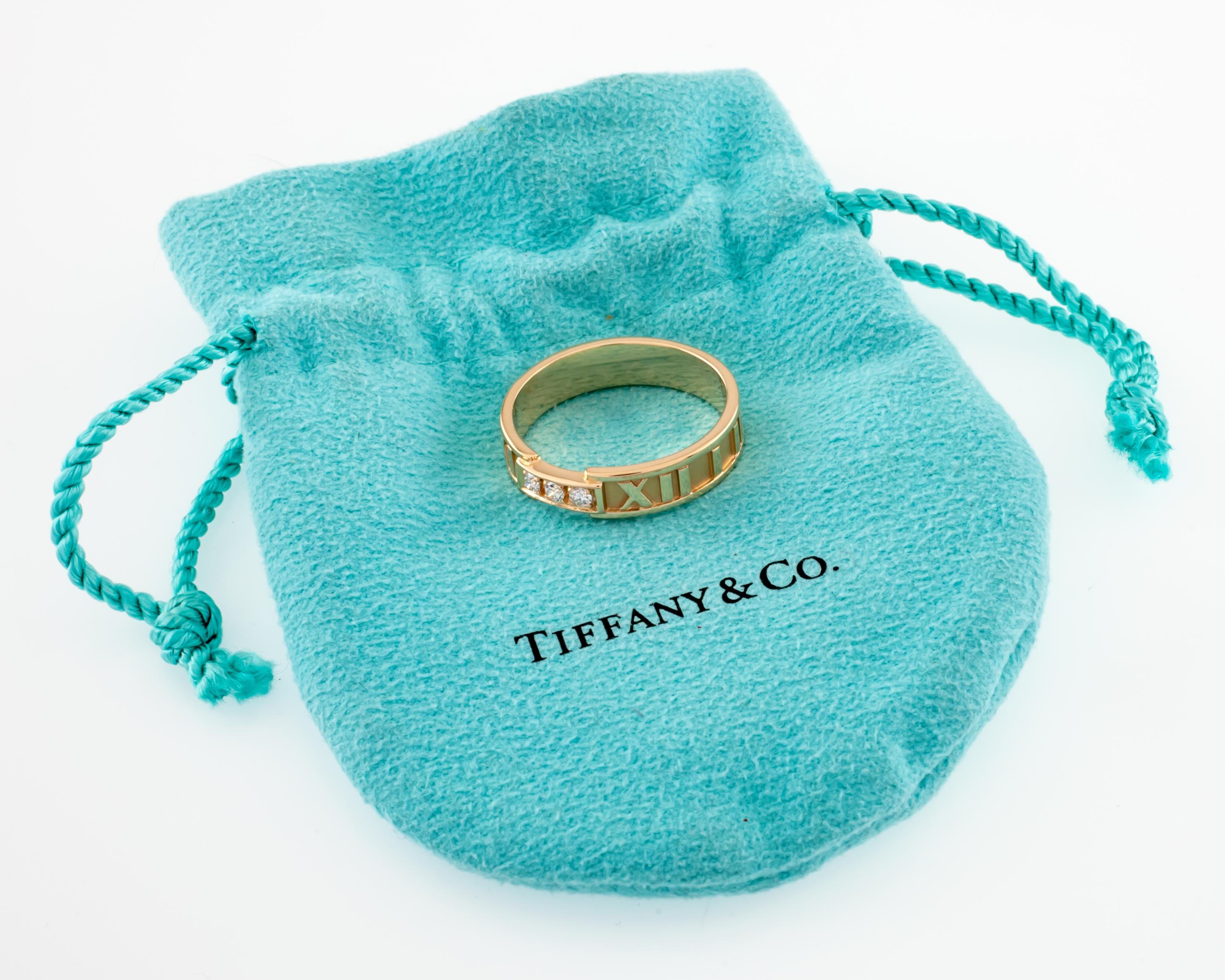 Gorgeous Band Ring by Tiffany & Co.
Features Iconic Atlas Design on Band w/ Three Pave Set Round Diamonds
Size 10.5
5 mm Wide
Total Mass = 6.0 grams
Piece is in Good Condition. Shows Few Signs of Aging or Wear. Include Original Tiffany & Co. Blue