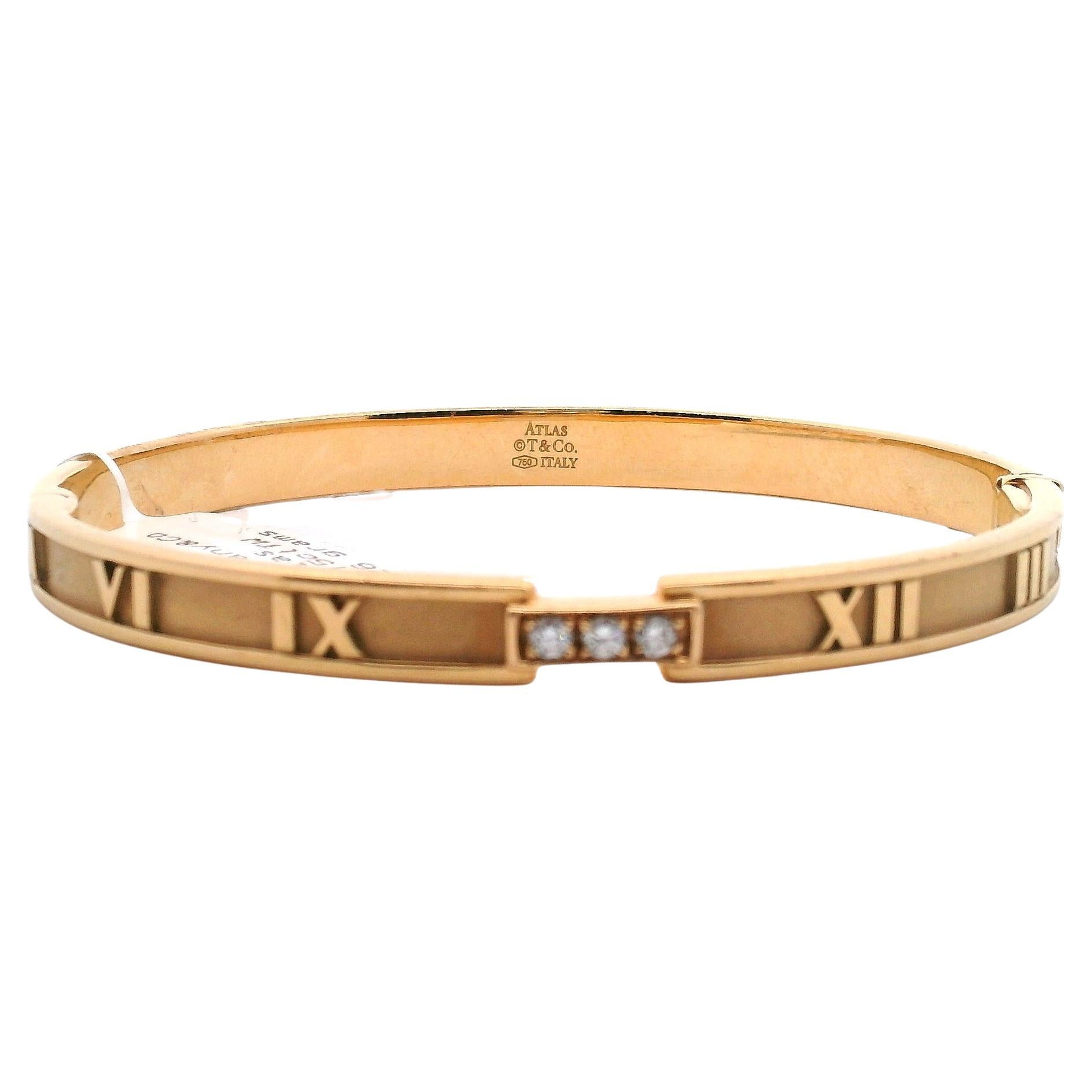This beautiful bangle is part of Tiffany & Co’s ‘Atlas’ collection. Made in 18kt. rose gold, this piece features Roman numerals around the bangle and is adorned with three diamonds grain set into the front with a combined carat weight of 0.15.