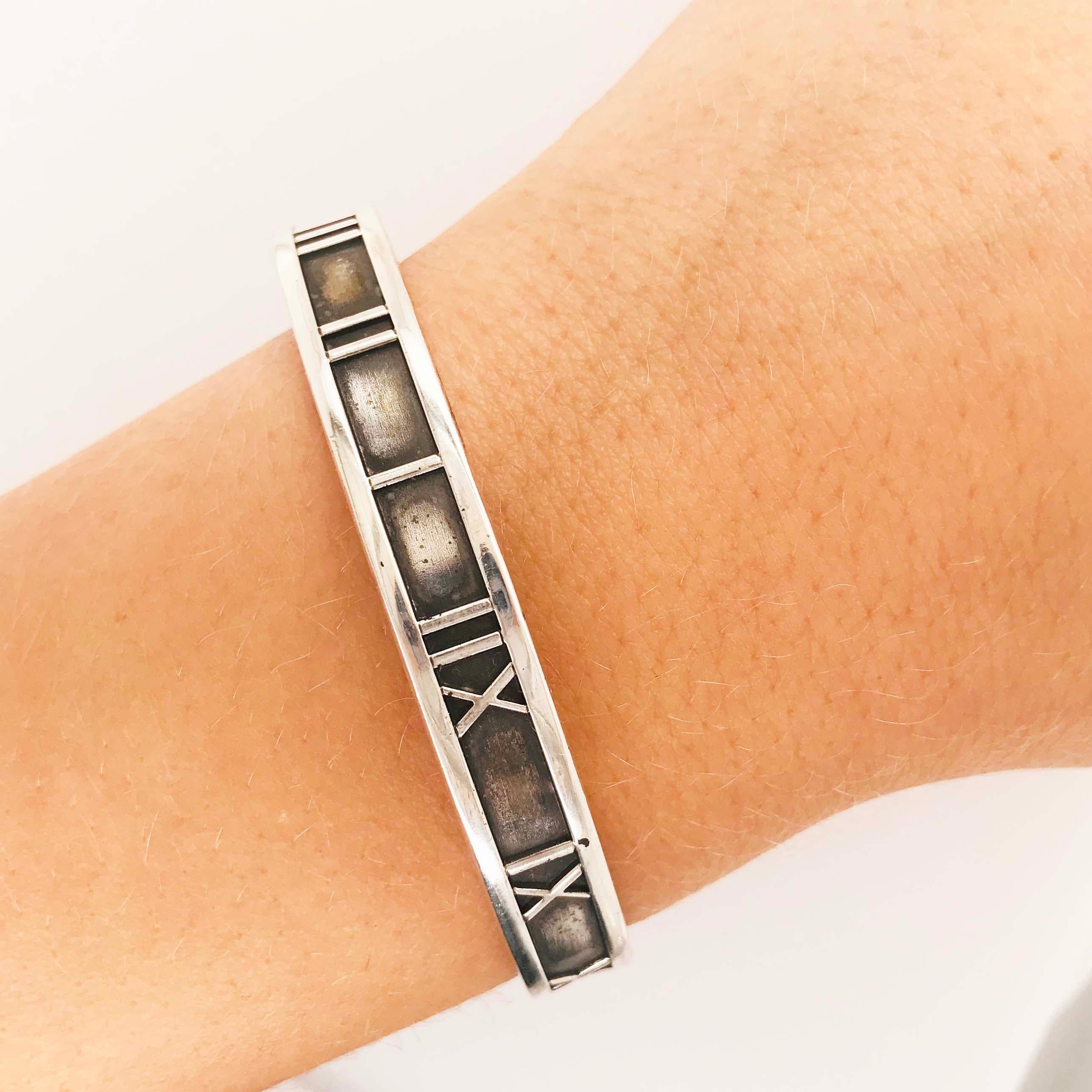 This gorgeous sterling silver cuff bracelet is an original, authentic Tiffany & Co. Atlas cuff bracelet. The Atlas cuff bracelet is an original 1995 Tiffany & Co. Atlas design with a sleek, classic Roman numeral design. The sterling silver bracelet