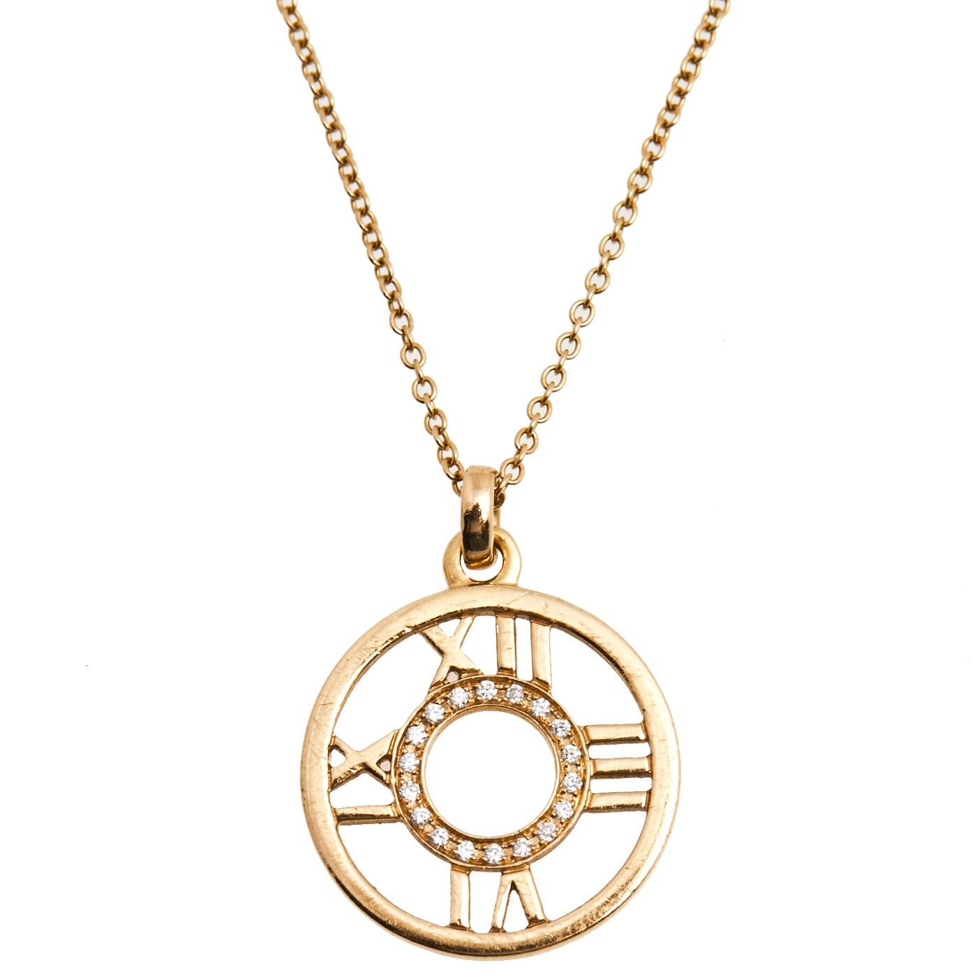 Presenting a beautiful necklace from Tiffany & Co.’s Atlas collection. An 18k yellow gold link chain holds a stunning circular pendant that has signature Roman numerals and sparkling diamonds placed within.

