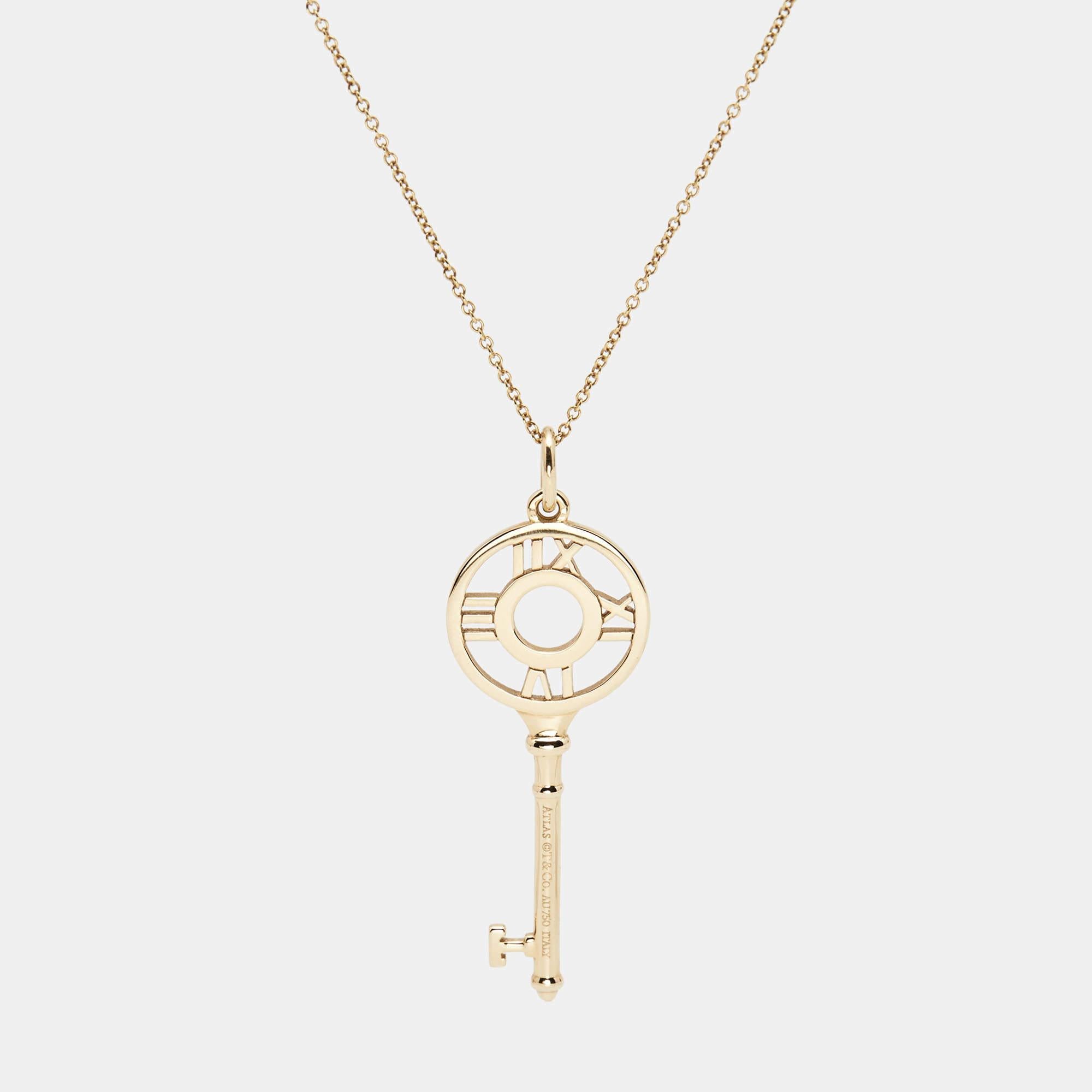 An elegant design from Tiffany & Co., this necklace features a delicate gold chain secured by a spring-ring clasp. The Tiffany key, with signature Roman numerals from the Atlas collection, forms the pendant. Diamonds give it a luxurious