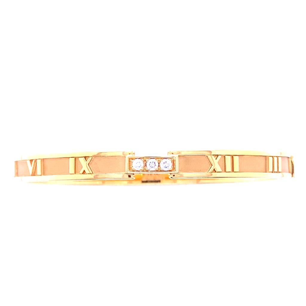 A Tiffany & Co. ‘Atlas’ diamond and rose gold bracelet, circa 2015.

From Tiffany & Co's iconic Atlas collection this jewel features Roman numerals to the circumference of the bangle and is set to its front centre with three elegantly placed grain