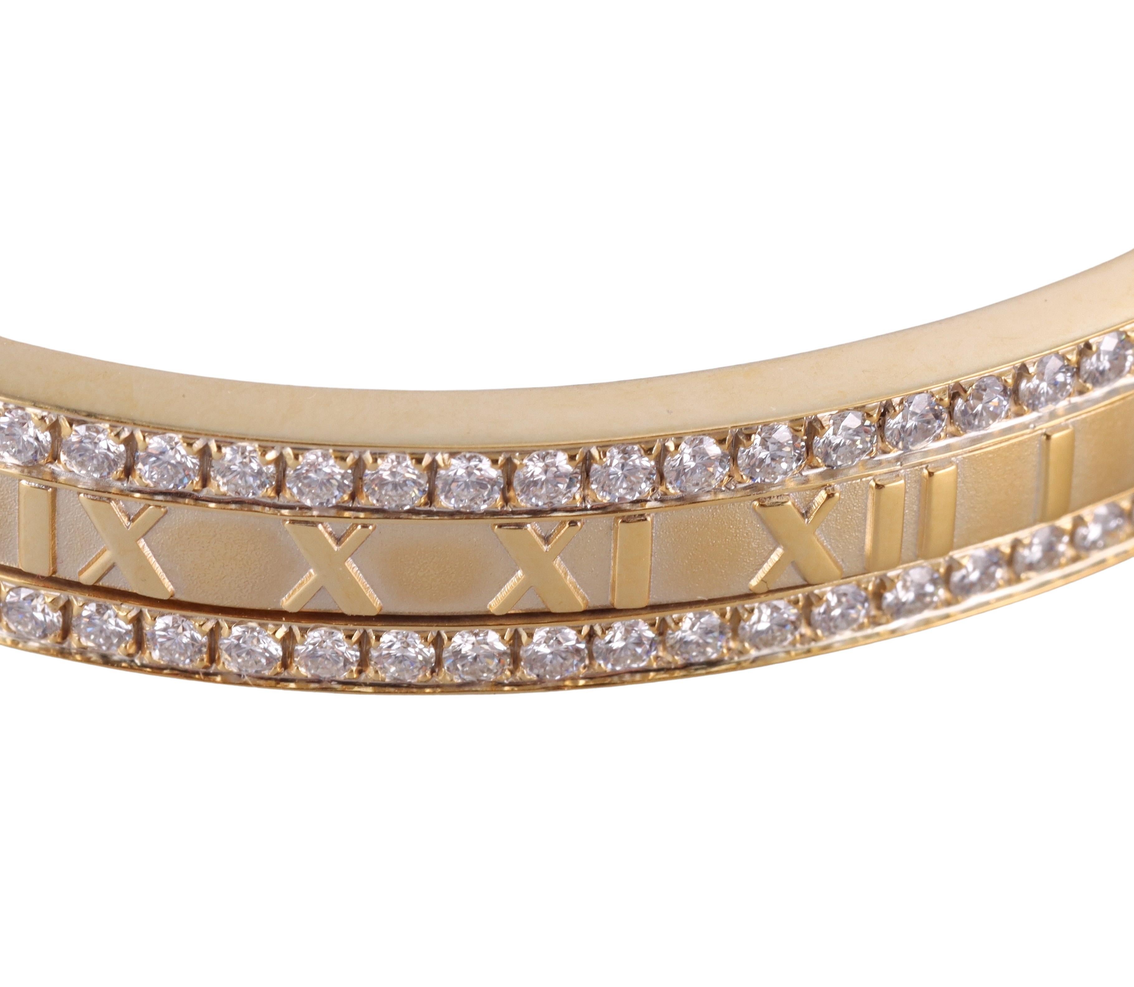 18k yellow gold Atlas bangle bracelet by Tiffany & Co, set with approx. 3.50ctw G/VS diamonds on one side of the bracelet. Will fit an approximately 7