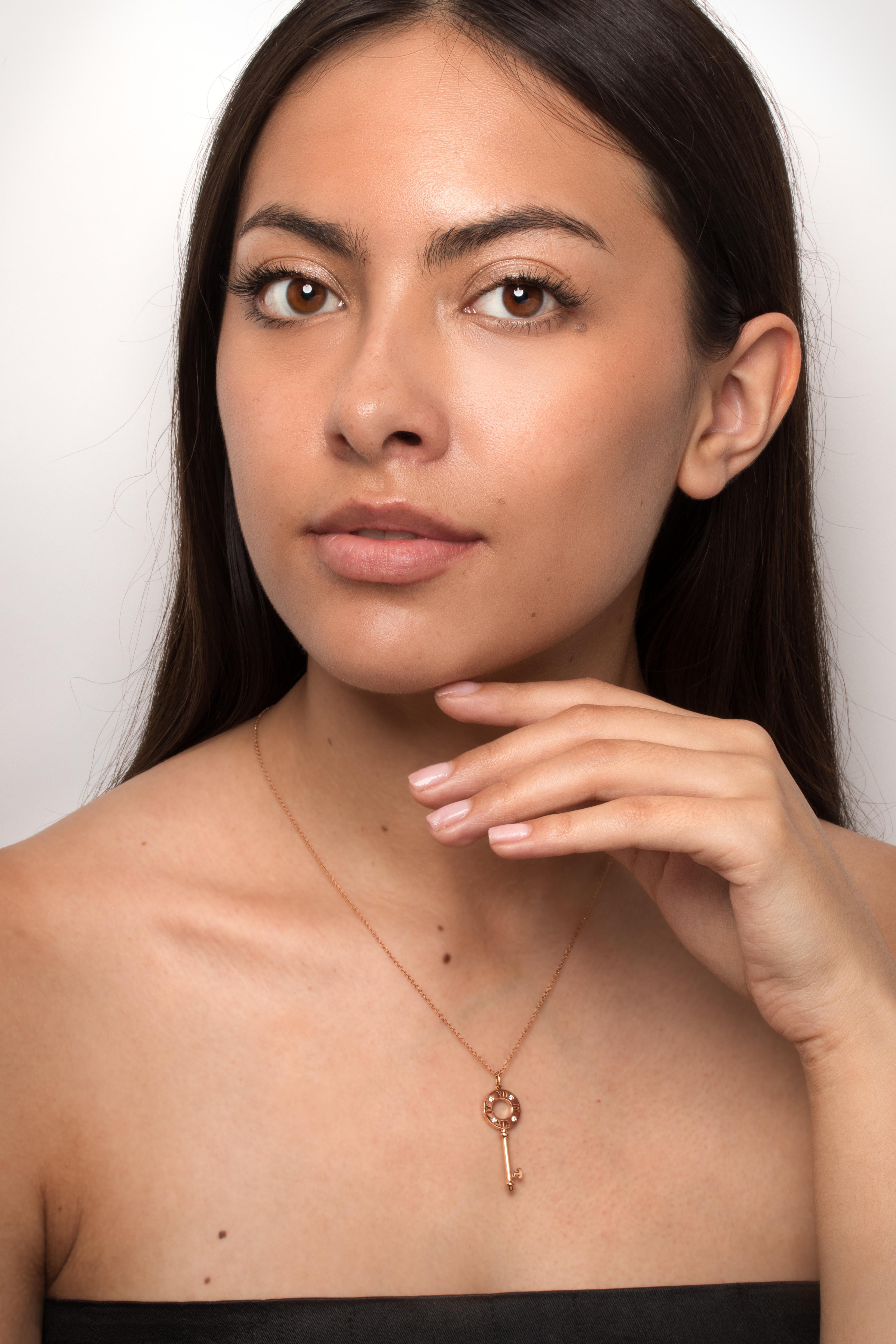 This beautiful diamond key pendant comes from Tiffany & Co.’s ‘Atlas’ collection. Around the key loop, the roman numerals of a clock face are broken up by four round brilliant diamonds totalling 0.04 carat. The diamonds are of F colour and VVS