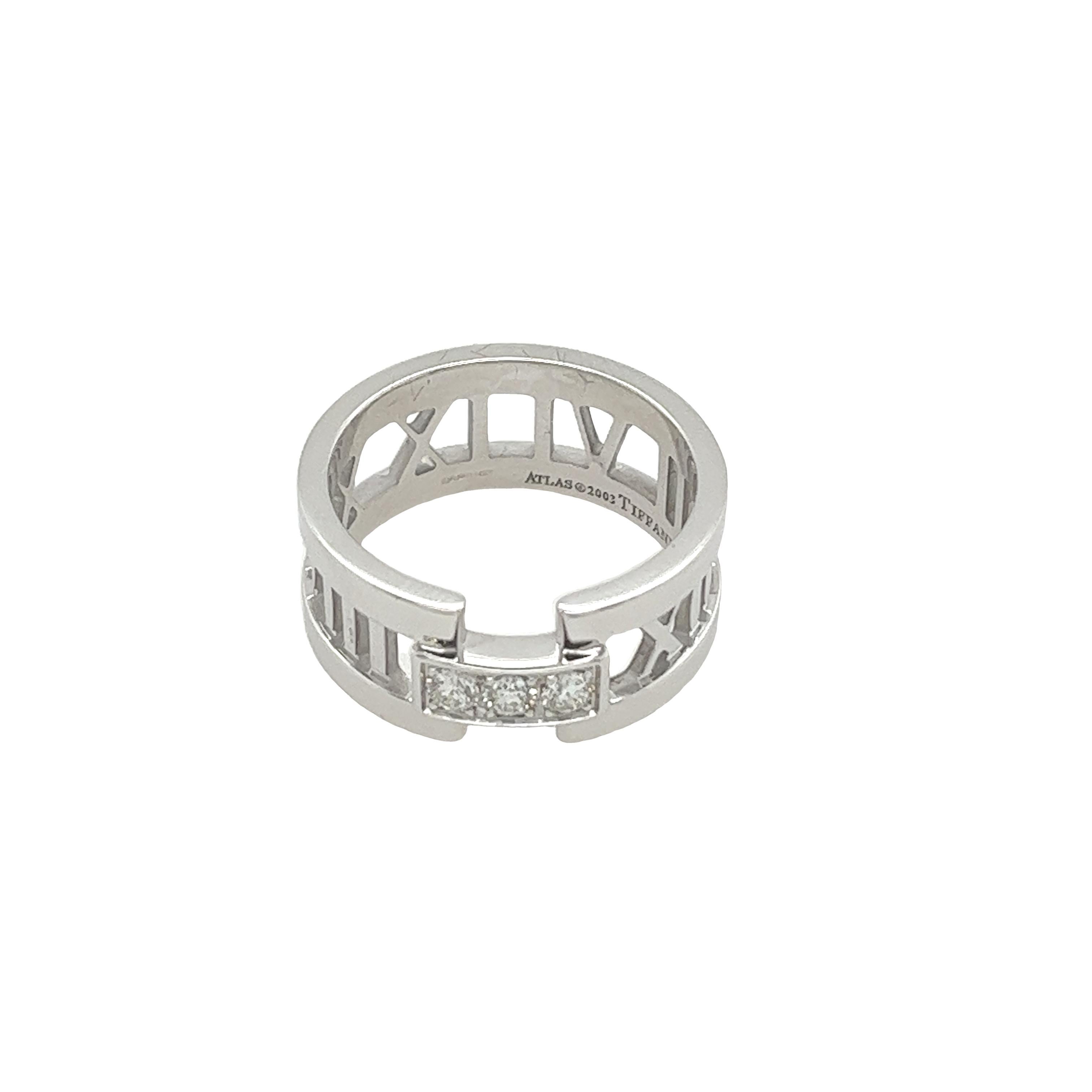 Elevate your style with this exquisite Tiffany & Co Atlas Band in 18ct White Gold.
This stunning ring features a modern design with interlocking gold bands that glimmer in any light. 
A trio of diamonds is elegantly set at the center, offering a