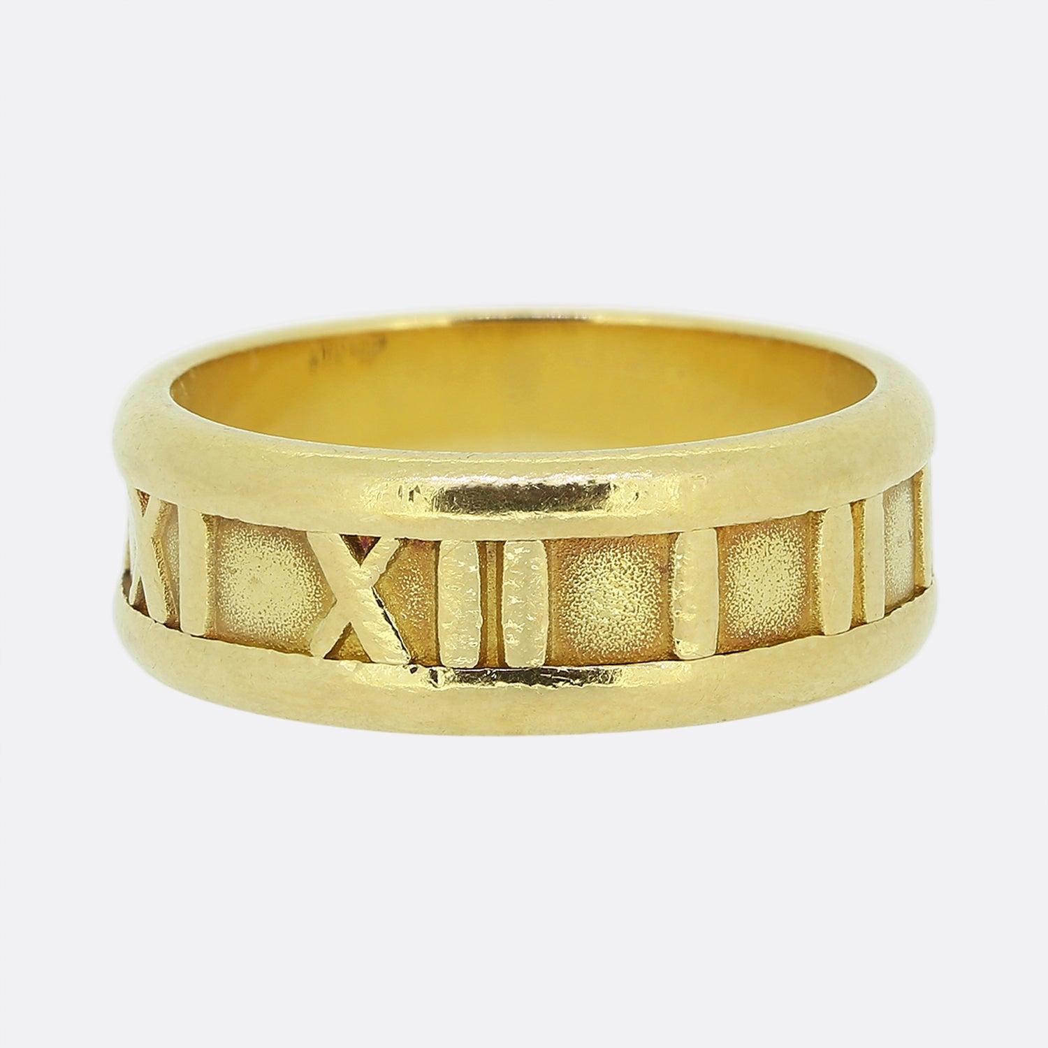 Here we have a classic ring from the world renowned jewellery designers, Tiffany & Co. This piece form part of their Atlas collection and showcases the iconic Roman numeral design around the entirety of an 18ct yellow gold band. 

Condition: Used