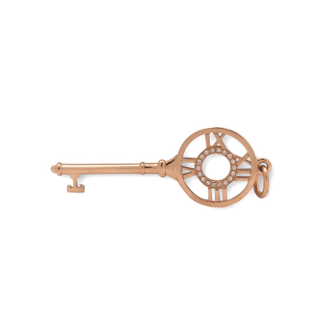 Authentic Tiffany & Co. key pendant from the 'Atlas' collection crafted in 18 karat rose gold. The classic Tiffany & Co. Atlas motif is set with approximately 0.04 carats of round brilliant cut diamonds. The pendant measures 1.90 inches in length