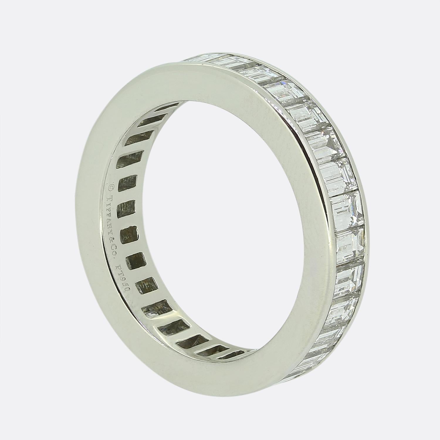 Here we have a platinum eternity band ring the world renowned jewellery designer Tiffany & Co. The straight baguette cut diamonds used here are arranged in a continuous line formation around the band, creating a seamless and elegant look. The band