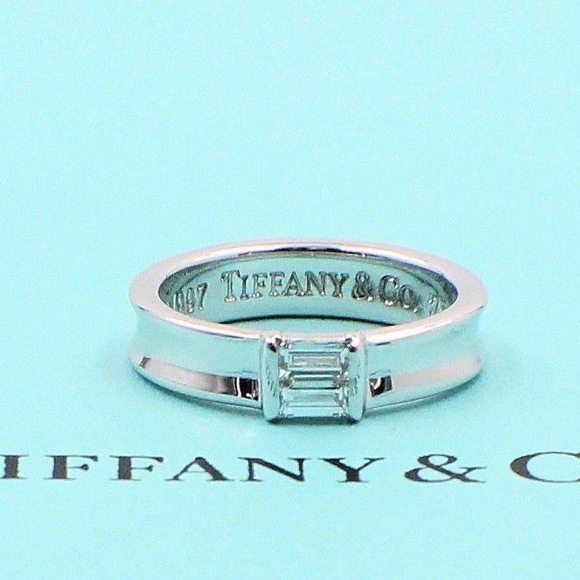 Tiffany & Co.
Style:  Stackable Baguette Diamond Band Ring
Metal:  18KT White Gold
Width:  4.5 MM
Size:  5.5 - sizable
Total Carat Weight:  0.24 CTS
Diamond Shape:   Baguette Diamond
Diamond Color & Clarity:  G / VS
Hallmark: 