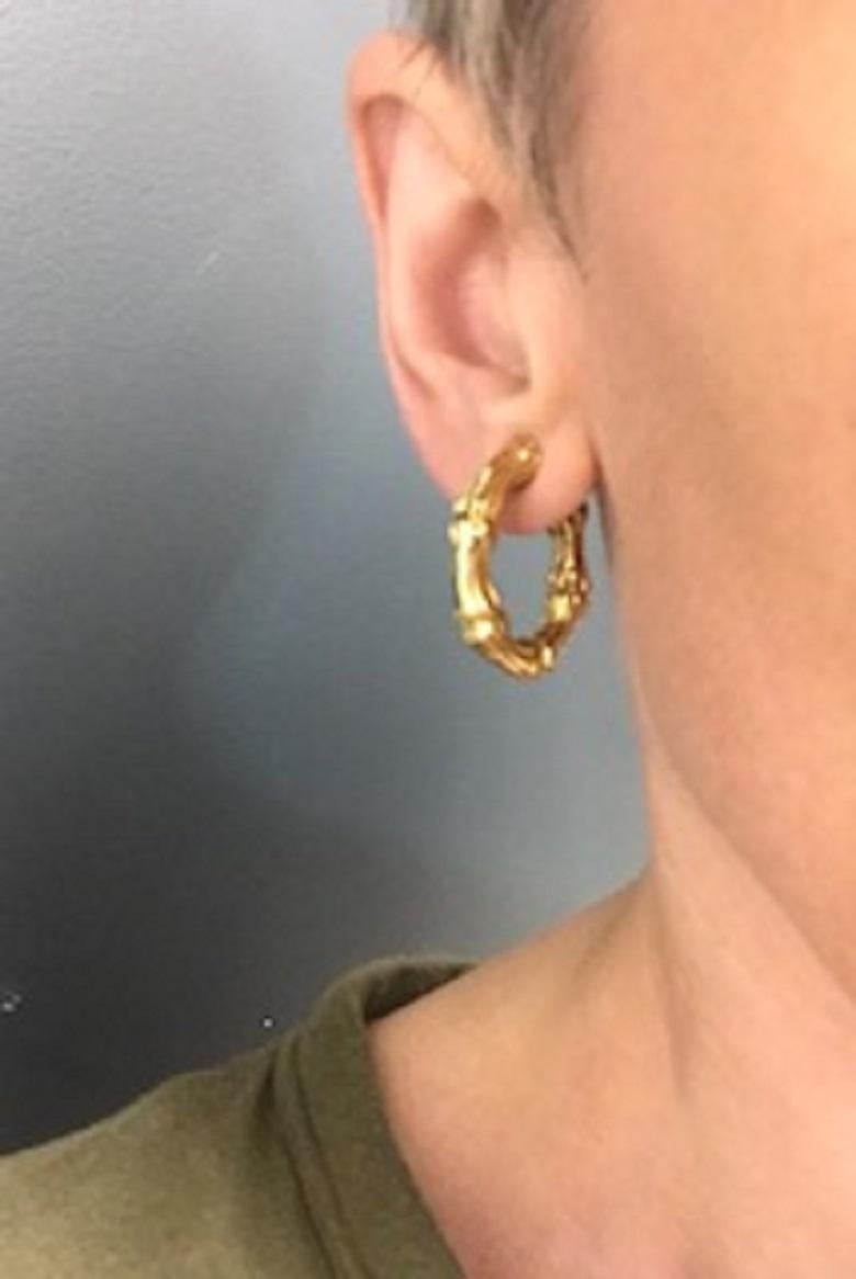 A classic pair of Bamboo hoop earrings by Tiffany & Co., crafted from 18k gold. The iconic bamboo design has been embraced by many jewelers, but Tiffany has mastered it. The hoop earrings are well-proportioned, and the gold is beautifully textured,