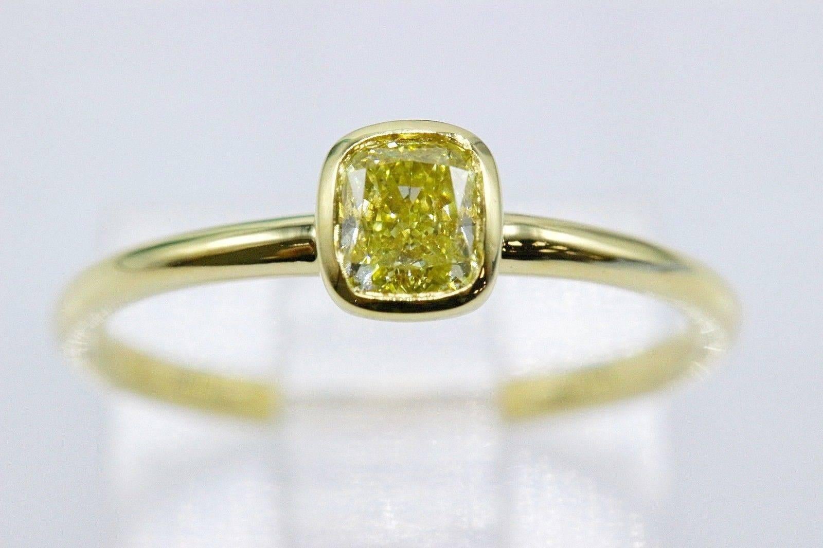 Tiffany & Co.
Style:  Bezet Fancy Intense Yellow Diamond Ring
Serial Number:  #31940079 / O04161797
Metal:  18KT Yellow Gold
Size:  4.25 - sizable  
Total Carat Weight:  0.41 CTS
Diamond Shape:  Cushion Modified Brilliant
Diamond Color & Clarity: 