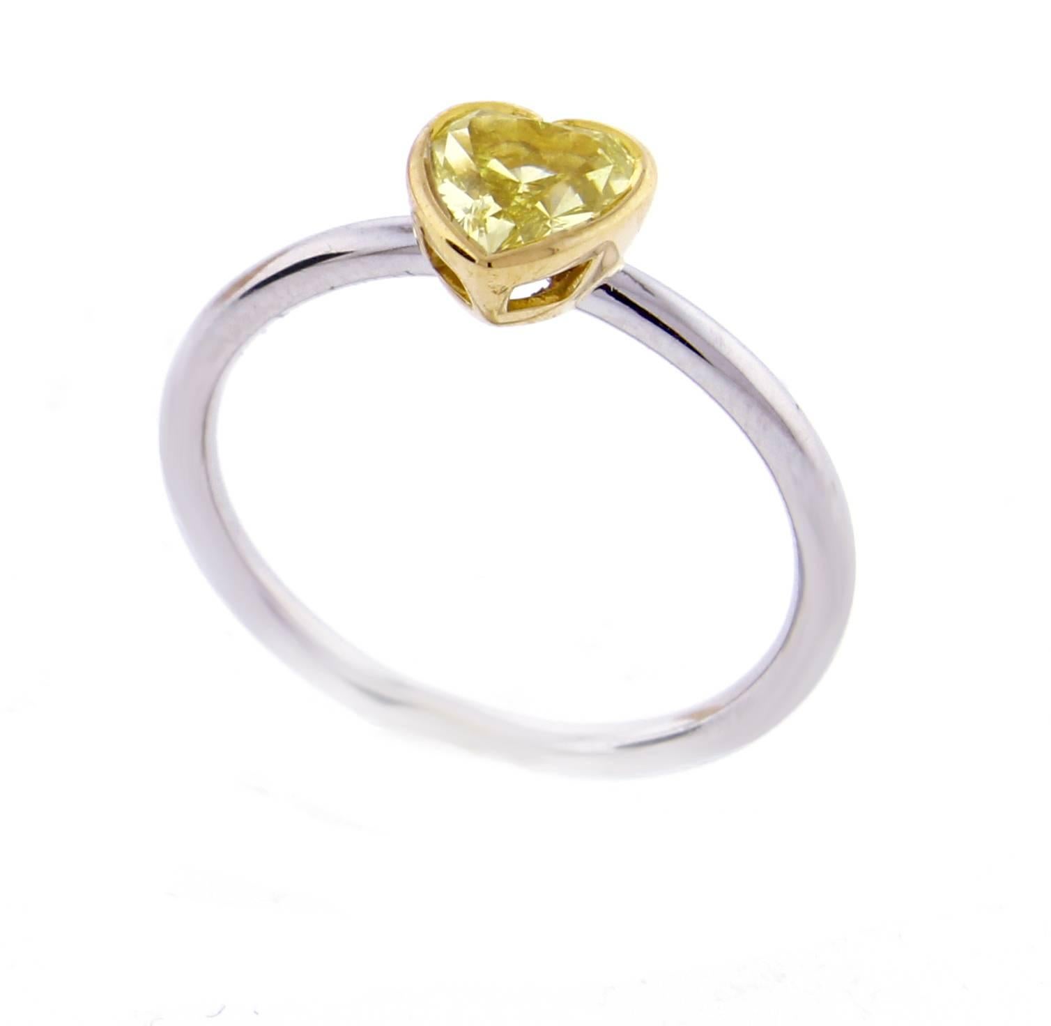 From Tiffany & Co.'s Bezet collection,  a stunning heart shape canary yellow diamond ring. The  .74 carat heart shape diamond is fancy intense yellow and internally flawless. Set in a Bezet of 18 kart gold on a platinum band. size 7
