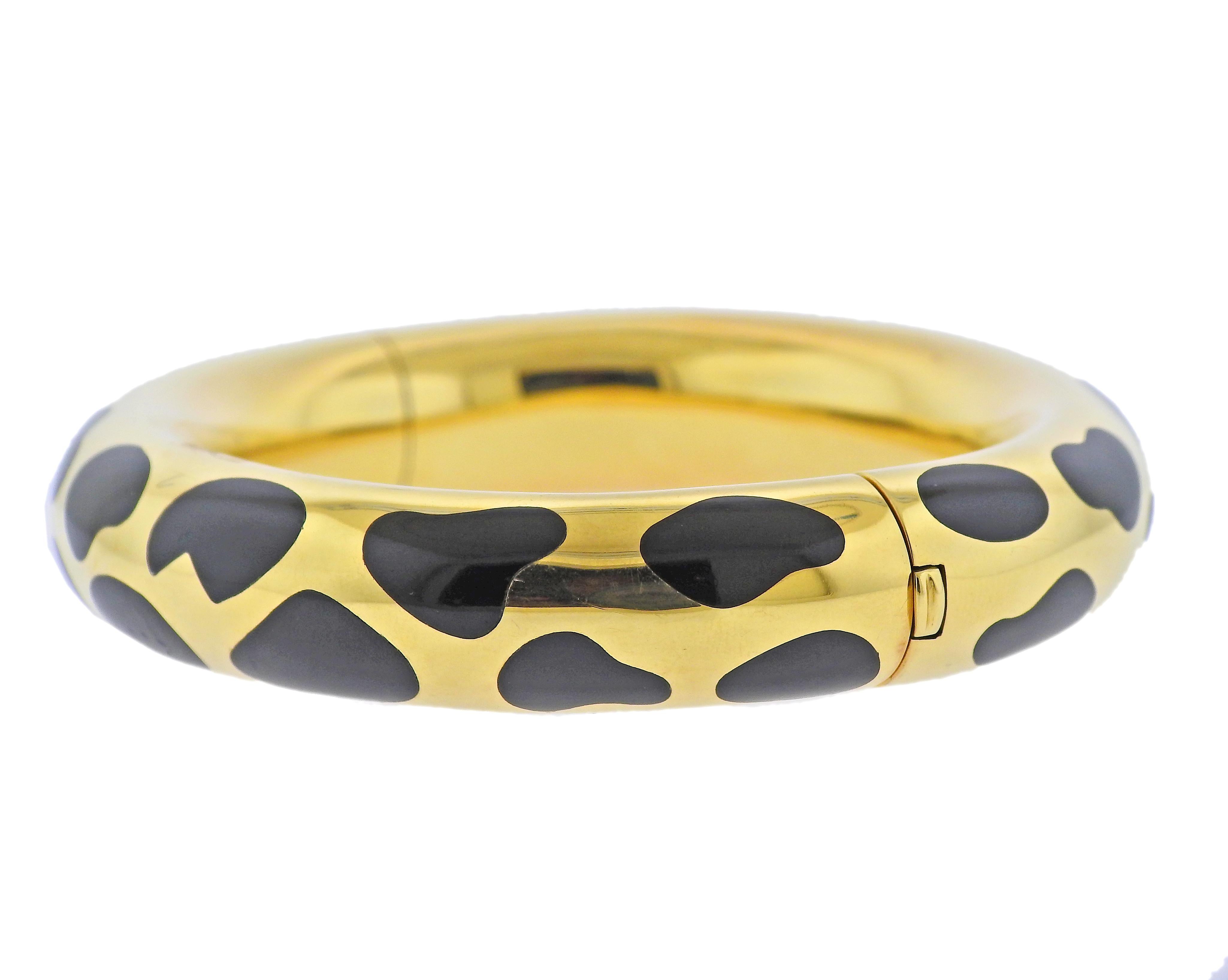 18k yellow gold bangle bracelet by Tiffany & Ci with inlayed black jade. Bracelet will fit up to 7.25