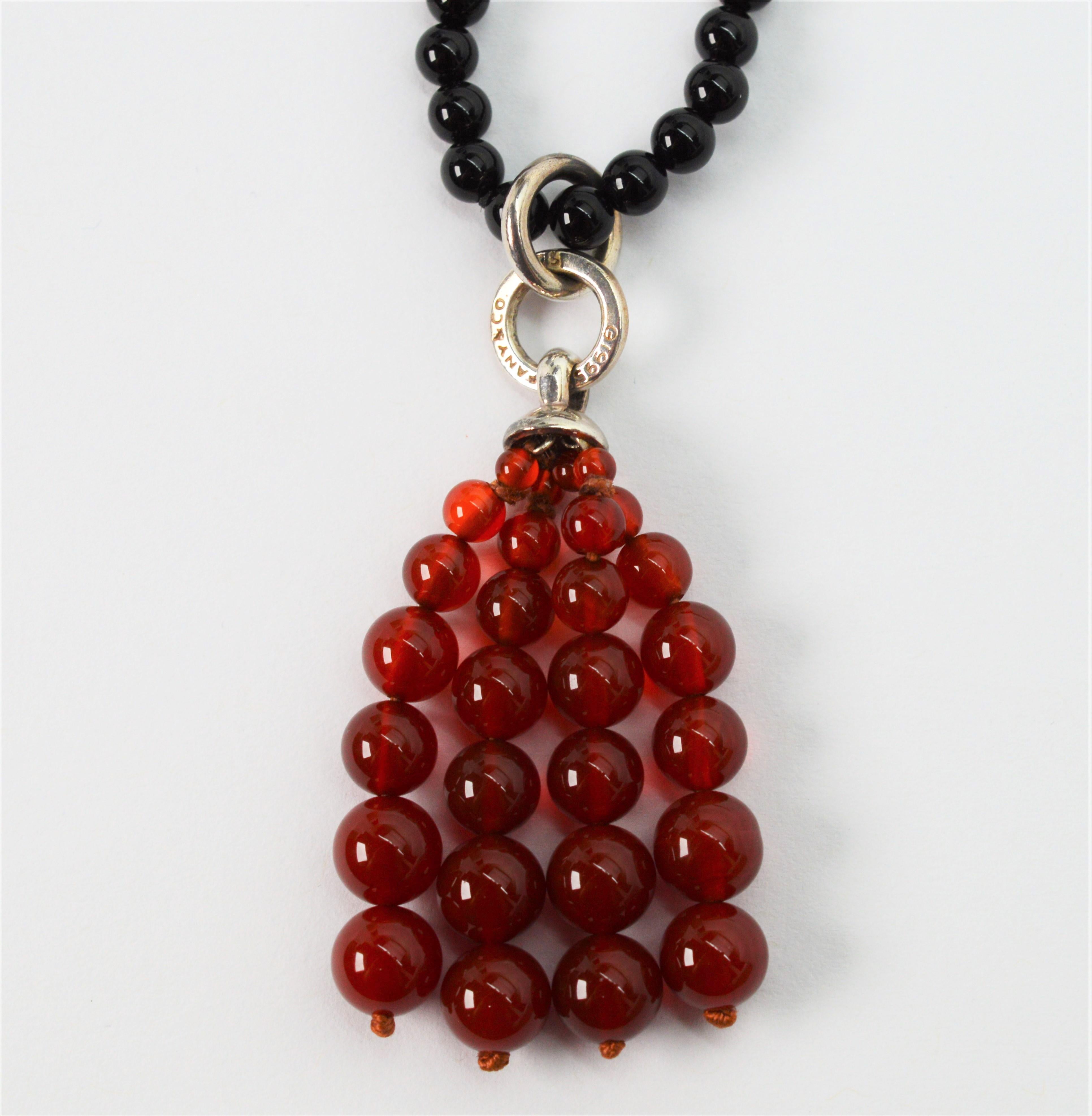 Enjoy this 1995 Collection Tiffany & Co. Onyx & Carnelian Beaded Tassel Necklace for it deep rich earthy tones and versatility. A thirty six inch strand of 4.25 mm polished black onyx beads leads to a removable 1-12/ inch tassel pendant enhancer of