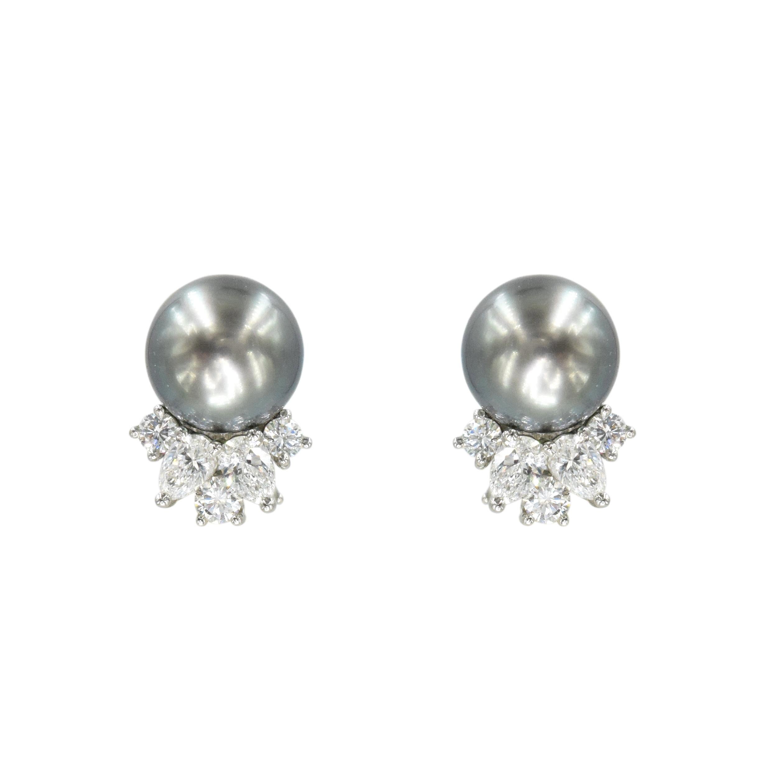 Tiffany & Co. Black pearl and diamond earrings in platinum. These earrings feature
9.5mm black pearls accented with 6 round brilliant cut and four pear shape
diamonds, set at the  bottom of the pearls. Total weight of the diamonds is approximately