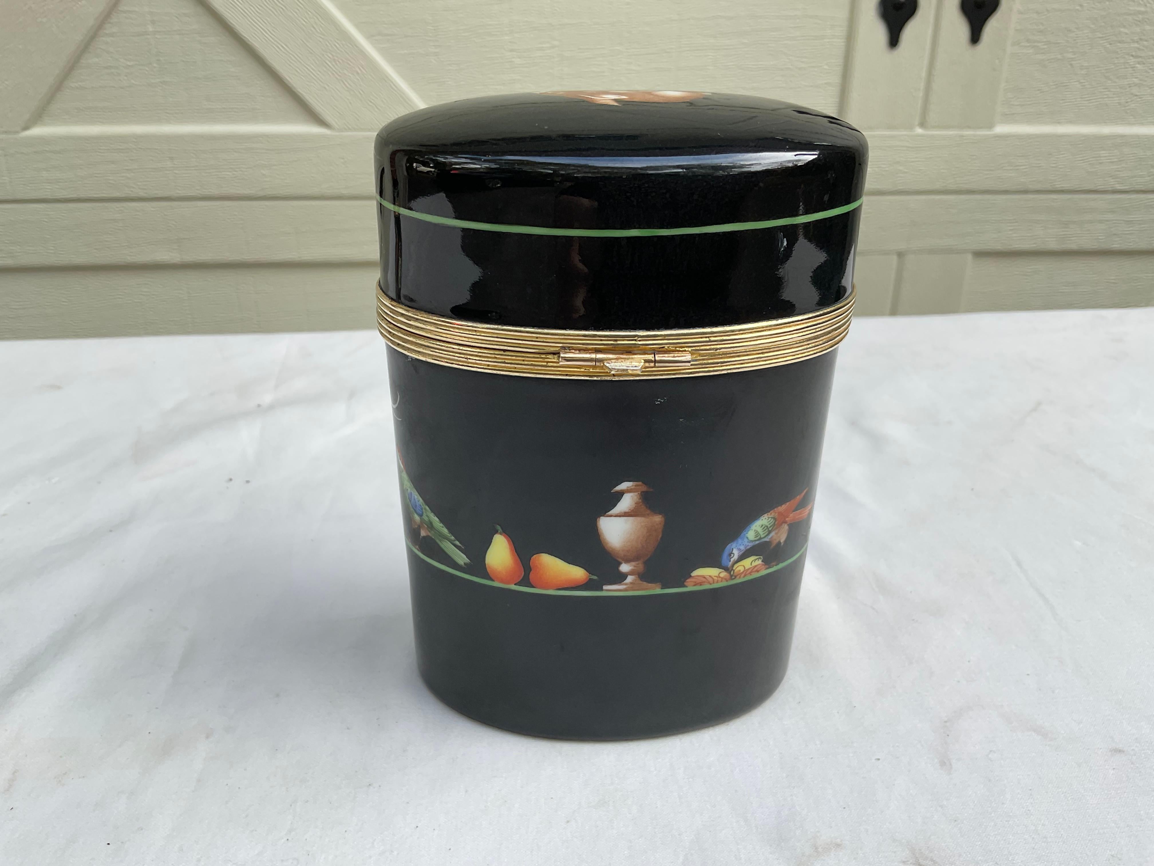 Beautiful oval porcelain  box, manufactured by Le Tallec, exclusively for Tiffany & Co. Bold black background with flora & fauna surrounding the piece. In very good estate condition, with no issues. 
