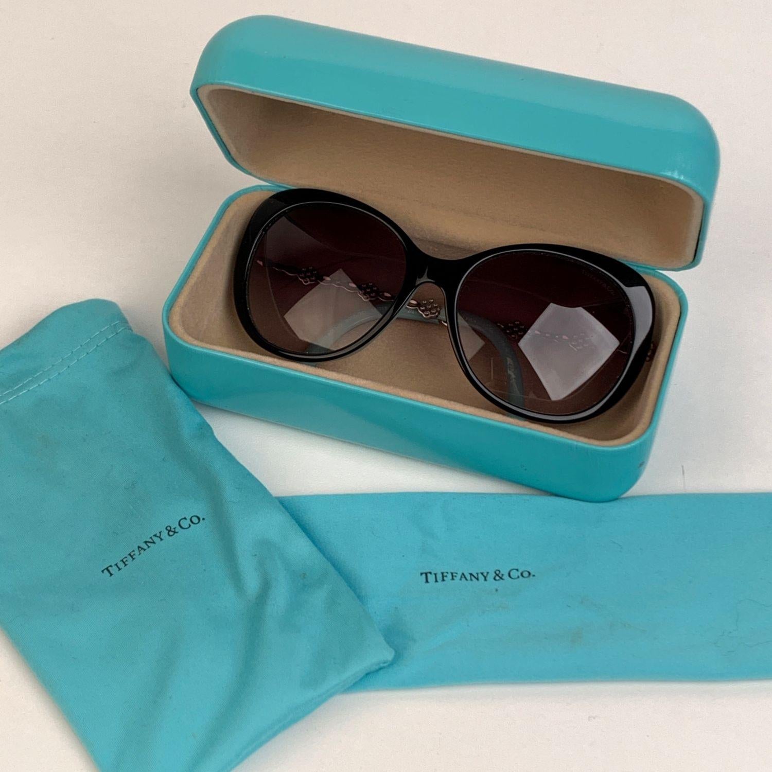 Tiffany & Co. Butterfly Sunglasses, mod. TF 4053-B. Black acetate frame with turquoise interior. Silver metal arms with beautiful crystal flowers. Gradient gray lenses. 100% UV protection. Frame Made in Italy. Mod & refs: TF 4053-B - 8055/3C - 56/17