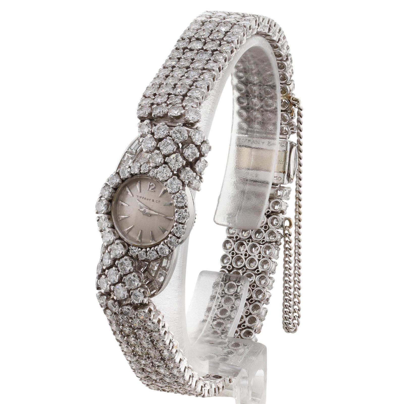 This exquisite authentic retro wristwatch was designed by Blancpain for Tiffany & Co. and is crafted in platinum and set with F-G-H VVS1-VVS2 diamonds weighing an estimated 15.0 - 16.0 carats. Part of the clasp is 18k gold and the safety chain was