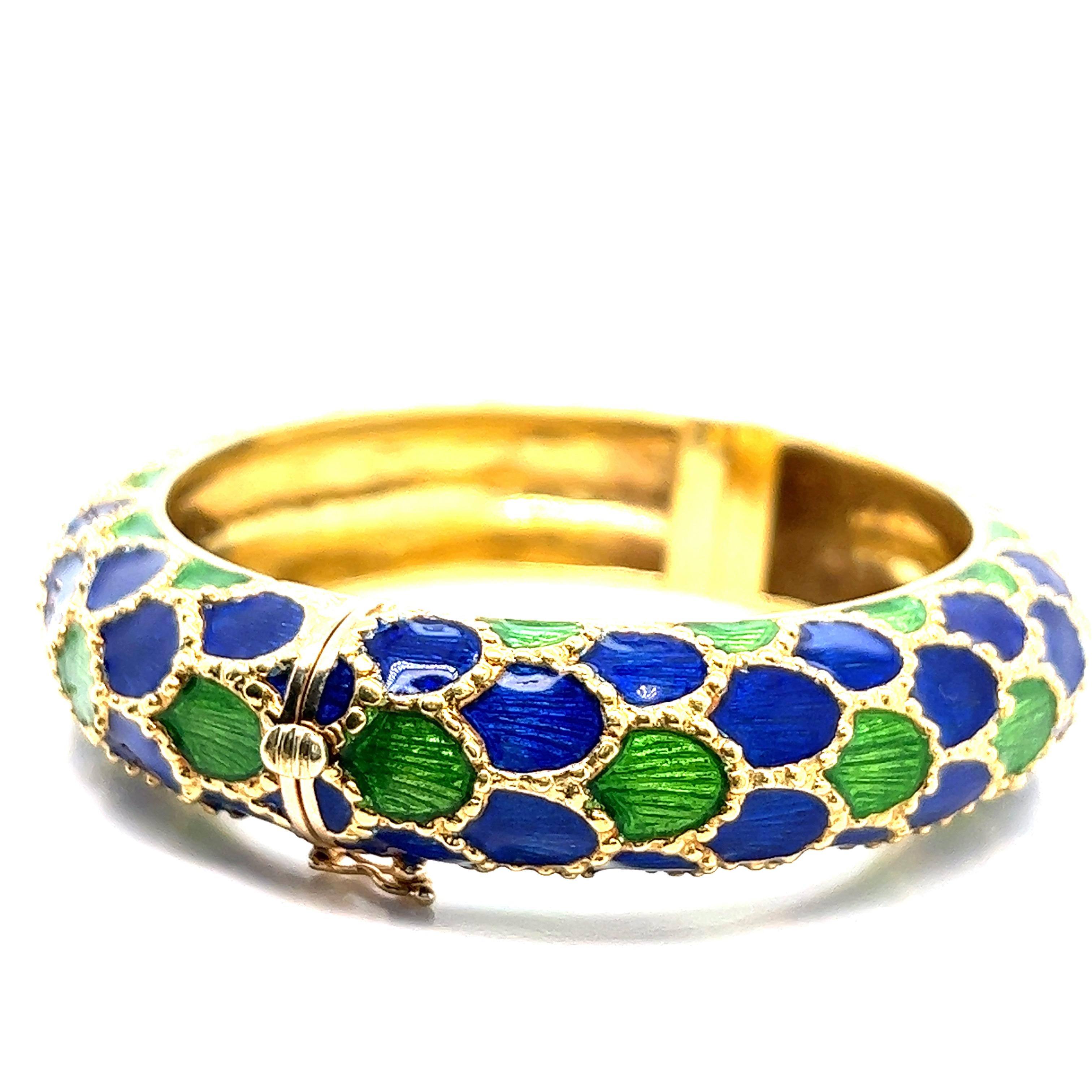 Tiffany & Co. 18 karat yellow gold bangle bracelet with royal blue and green enamel. It features a fish scale design throughout. Marked: Tiffany / 18k. Total weight: 82.9 grams. Width: 3 inches. Length: 2.75 inches. Inner circumference: 7 inches.  