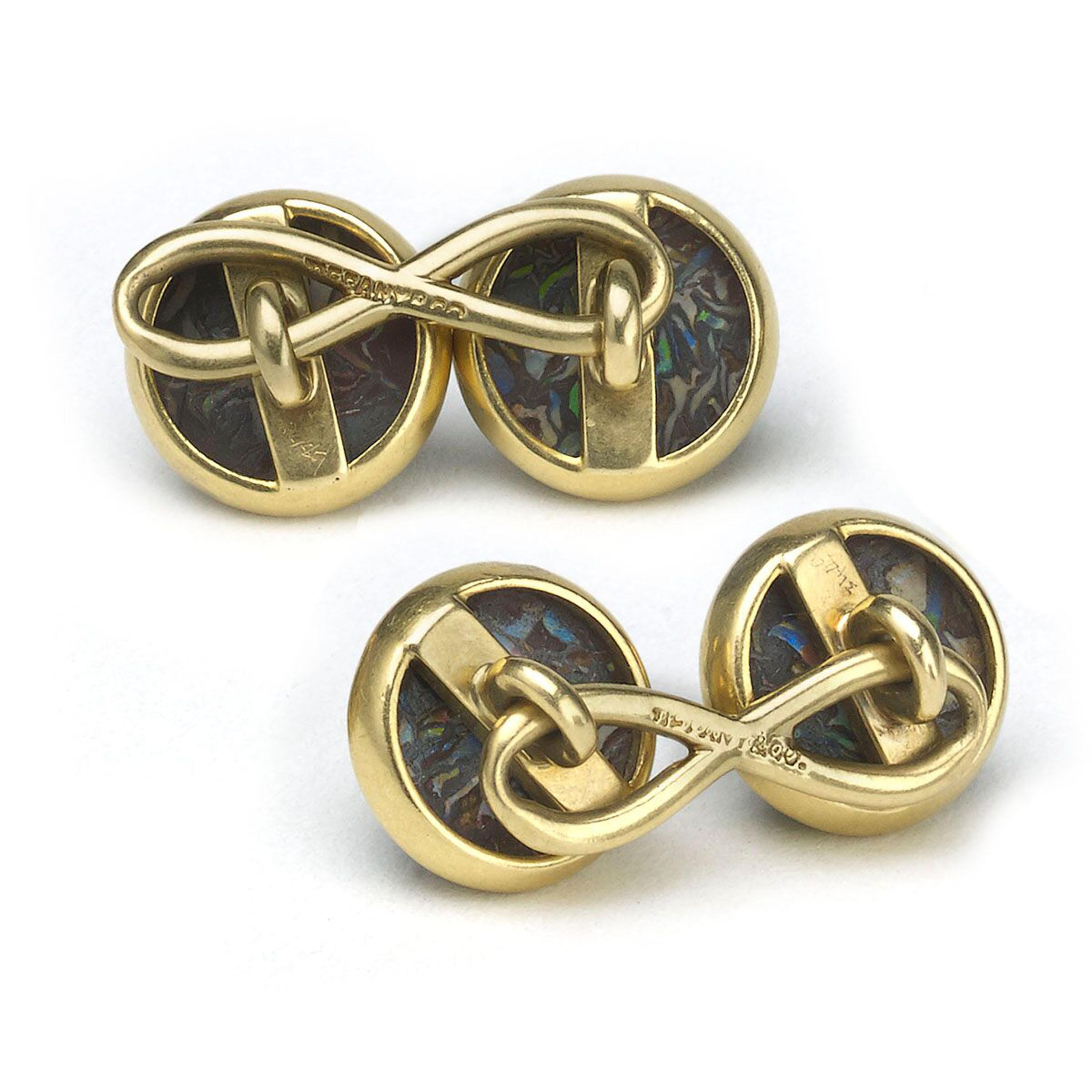 A pair of antique Tiffany & Co. cabochon boulder opal cufflinks, each set with a circular domed boulder opal matrix, mounted in gold, with figure-of-eight links, signed 