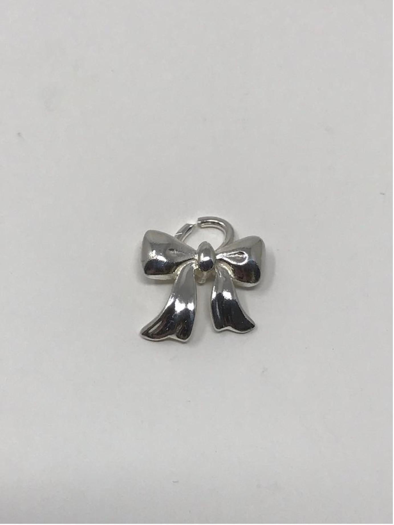 Item - Tiffany & Co. Bow Charm/Pendent

Condition - Exceptional

SKU - 1544

Original Retail Price - $275 + tax

Dimensions - 17mm x 15mmm x 7mm

Material - Silver .925

Weight - 2 oz

Comes with - Dust Bag

Available in Store - No