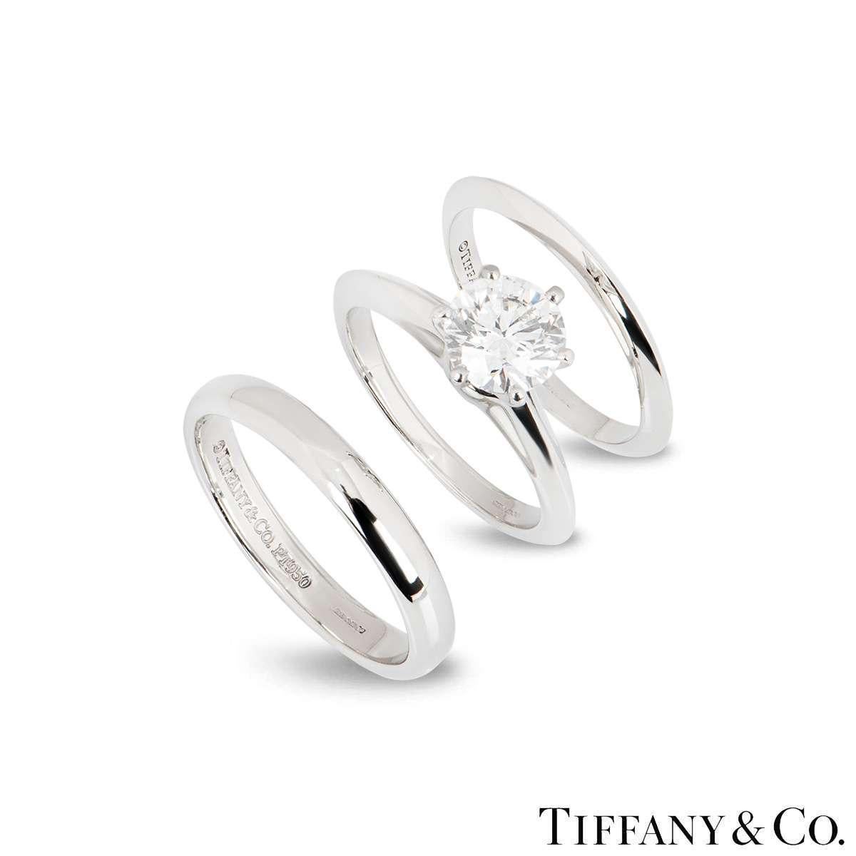 A beautiful platinum diamond bridal set by Tiffany & Co. The set consists of a diamond engagement ring and two polished bands. The diamond ring is set with a 1.21ct round brilliant cut diamond, H colour, VS1 clarity and is a size K (UK), US 5 1/8, .