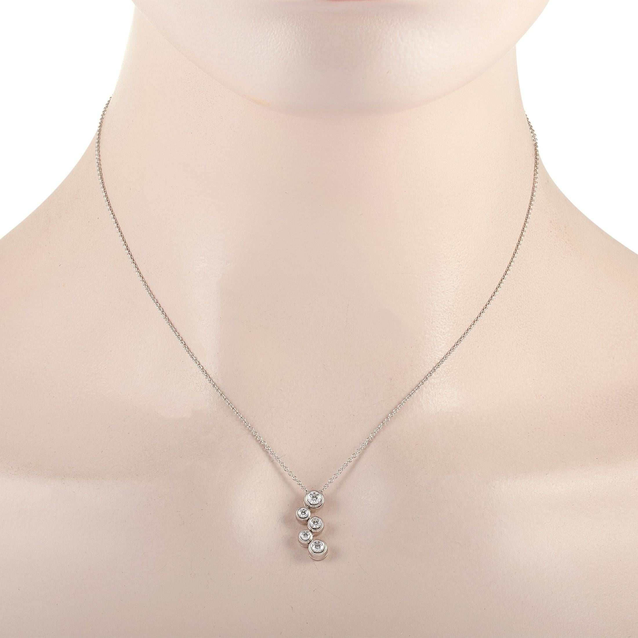 The Tiffany & Co. “Bubble” necklace is made of platinum and weighs 5.4 grams. It is presented with a 16” chain and boasts a pendant that measures 0.63” in length and 0.25” in width. The necklace is embellished with diamonds that amount to 0.50