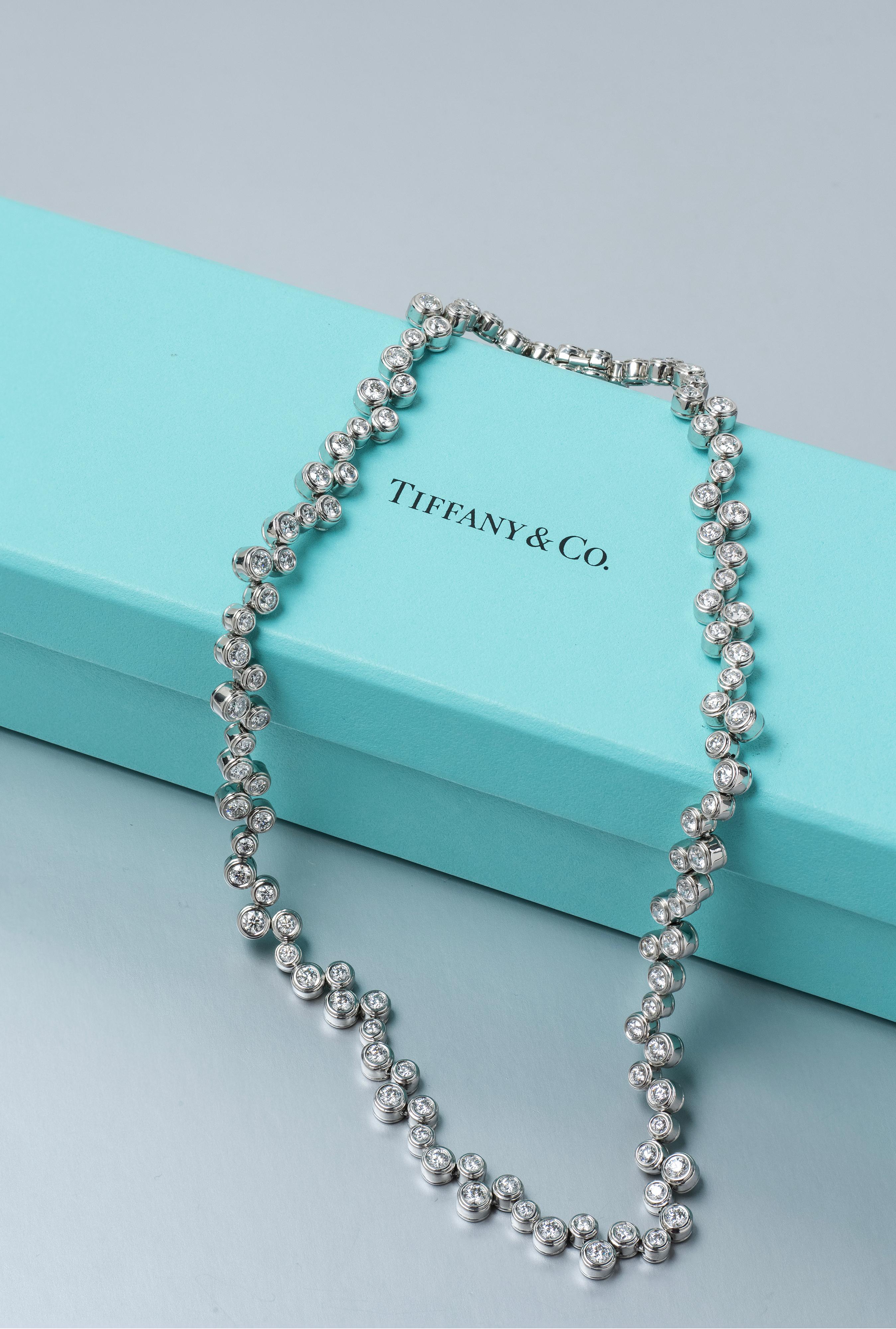 Gemstone
Main Stone: Diamond 10ct.
Metal: Platinum 950

        This exquisite Tiffany & Co. Platinum Diamond Necklace is a testament to timeless elegance and expert craftsmanship. Featuring 110 round diamonds, each meticulously set, the necklace