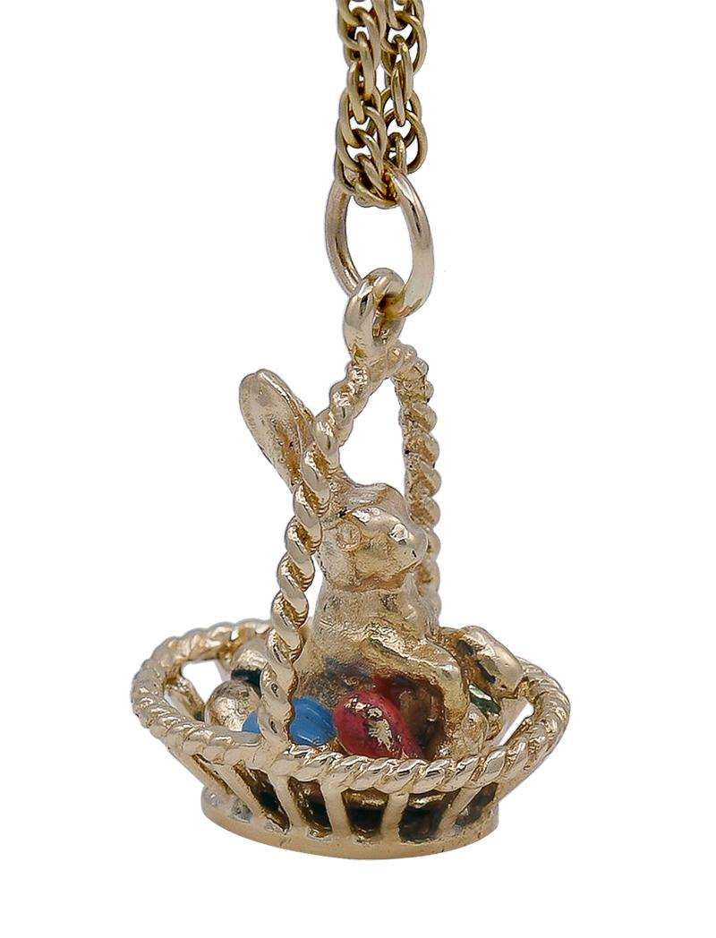 Adorable figural charm:  a bunny sitting in a basket with four enamel eggs.  Made and signed by TIFFANY & CO.  18K yellow gold. 3/4