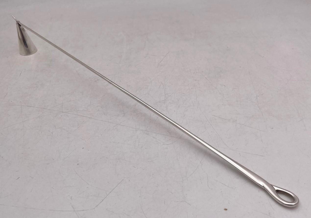 Tiffany & Co. sterling silver candle snuffer, designed by the celebrated Elsa Peretti, in Mid-Century Modern style, with an elegant, geometric design. It measures 17'' in length by 2 1/8'' in height and bears hallmarks as shown. 

The legendary