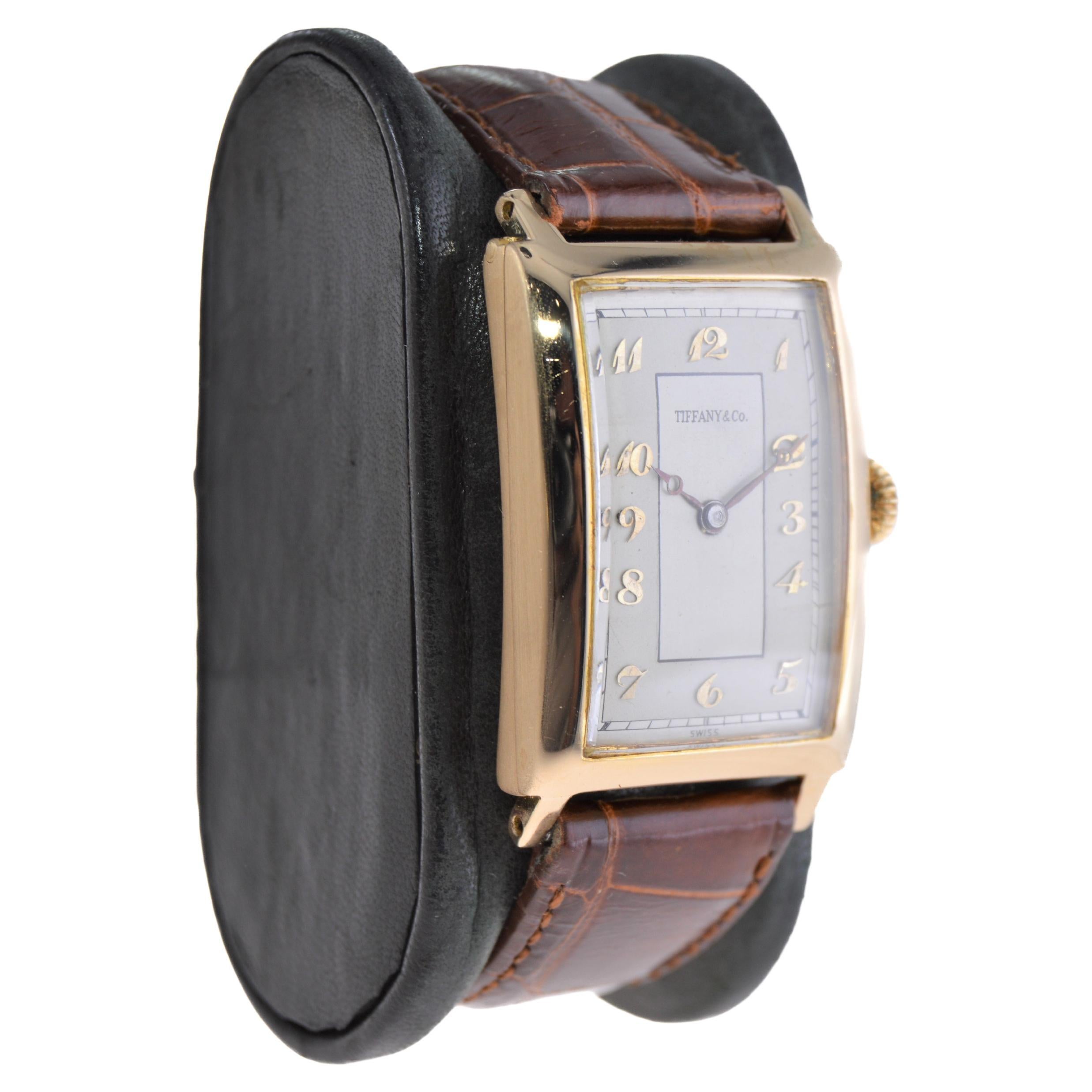 FACTORY / HOUSE: International Watch Company for Tiffany & Co.
STYLE / REFERENCE: Art Deco Tank / Hinged Case 
METAL / MATERIAL: 18Ktl. Yellow Gold
CIRCA / YEAR: 1930's
DIMENSIONS / SIZE: Length 43mm x Width 25mm
MOVEMENT / CALIBER: Manual Winding /